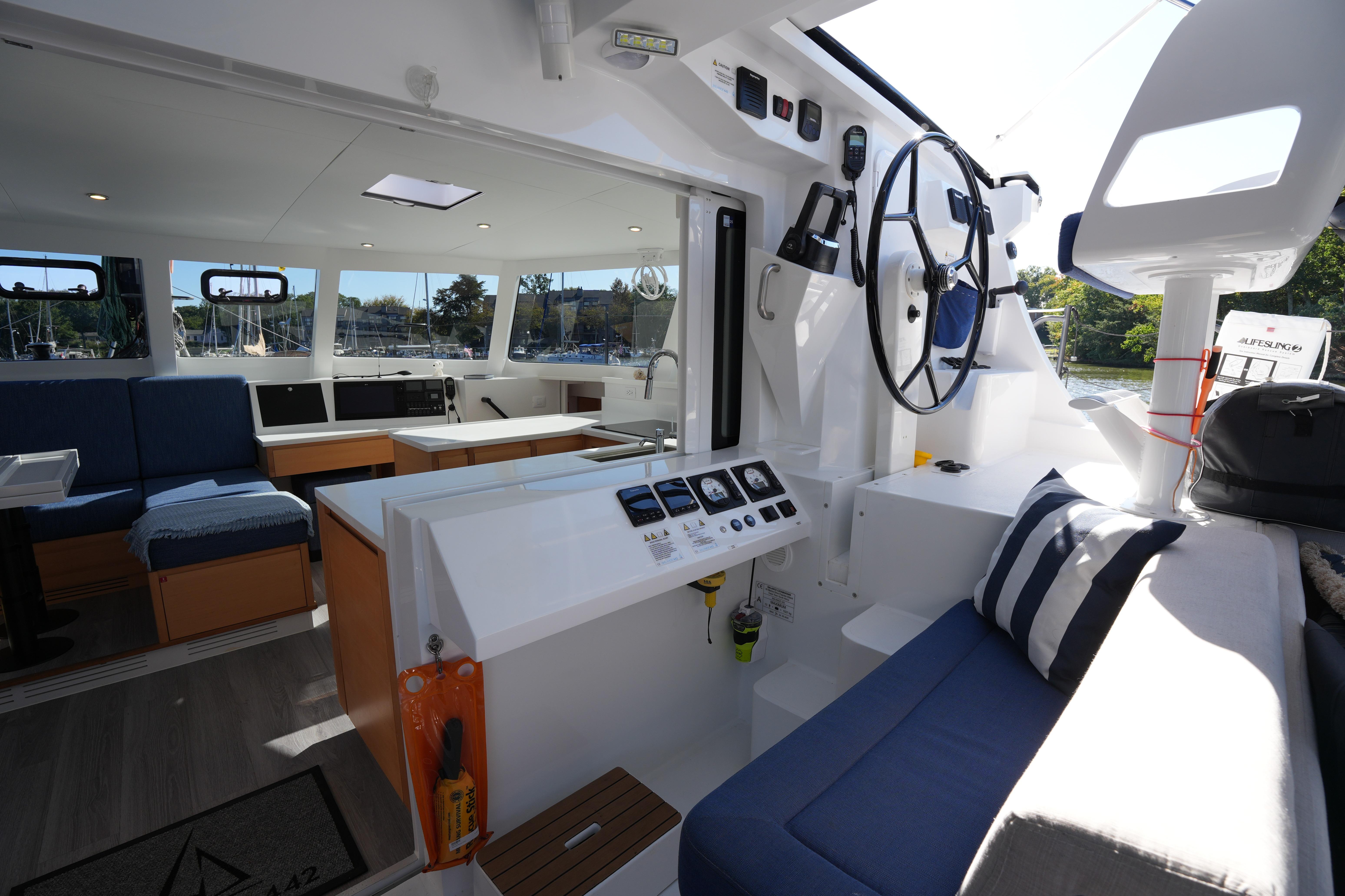 Modern interior of 2024 Balance 442 yacht with steering wheel and seating area.