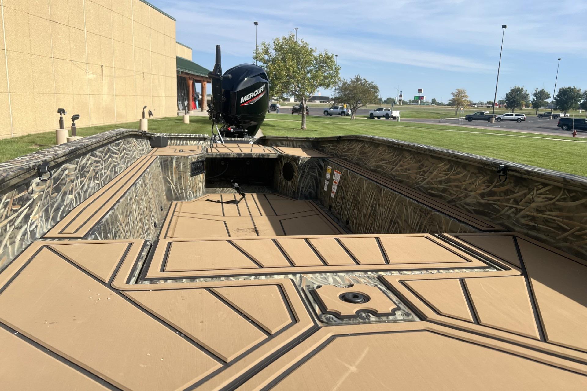 2026 Tracker Grizzly 1650 T Prairie Wings Edition boat with camo design and Mercury engine.