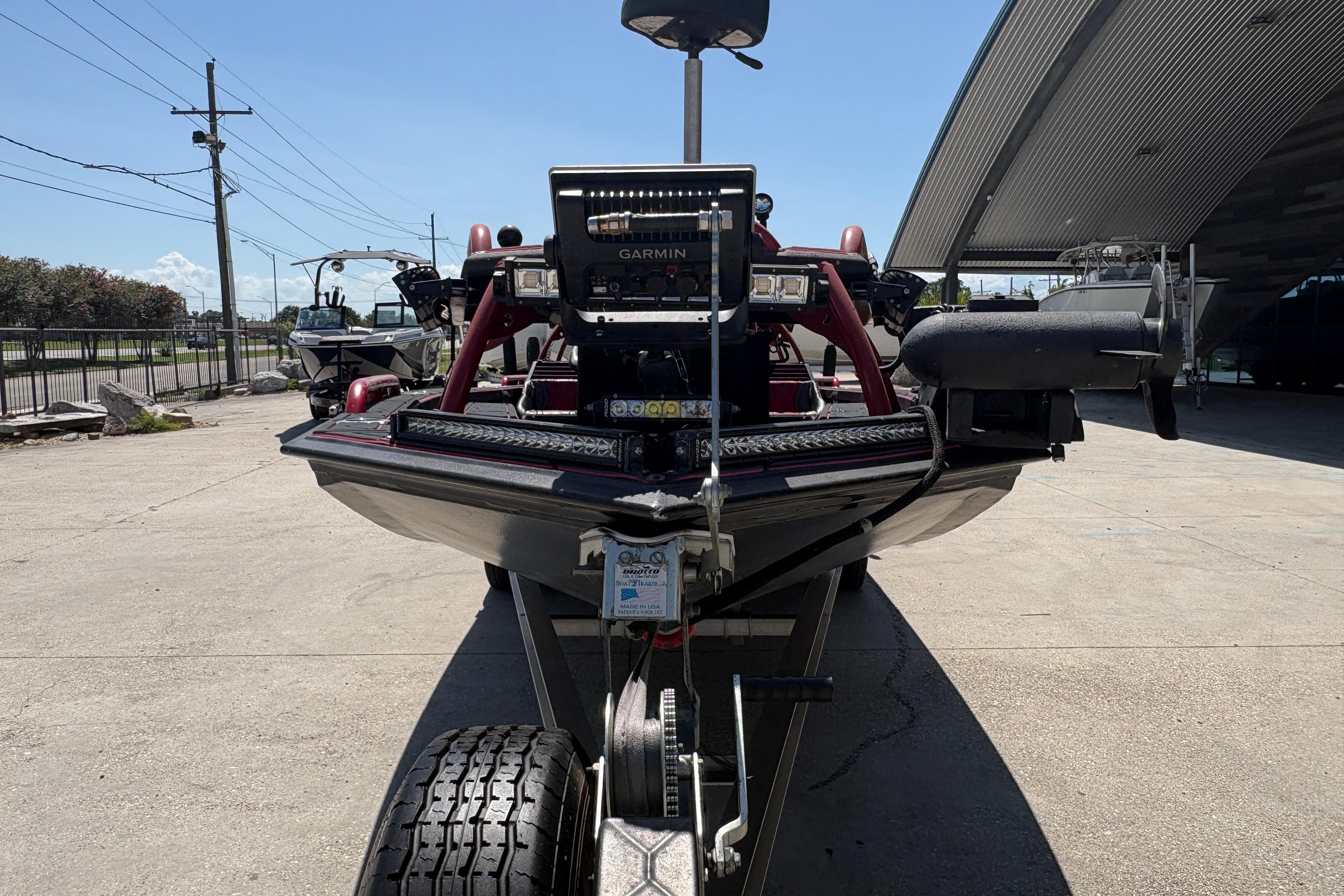 Front view of a 2018 Custom Swamp Shark 24' boat on a trailer, outdoors.