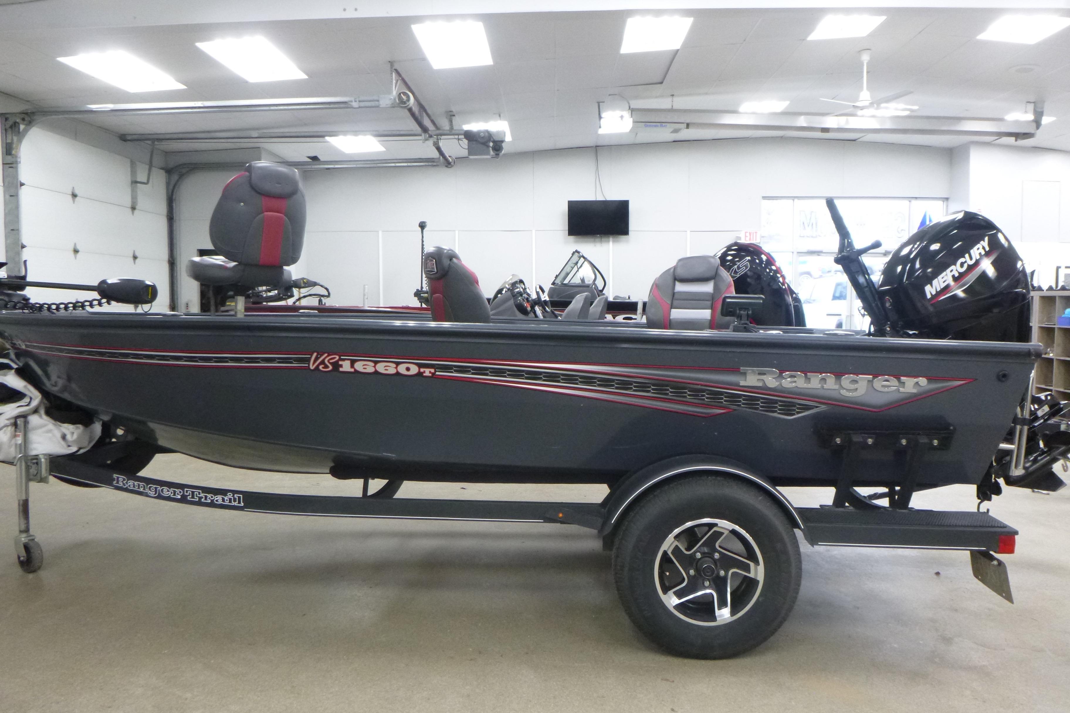 2021 Ranger VS1660 T fishing boat in a garage with Mercury outboard motor.