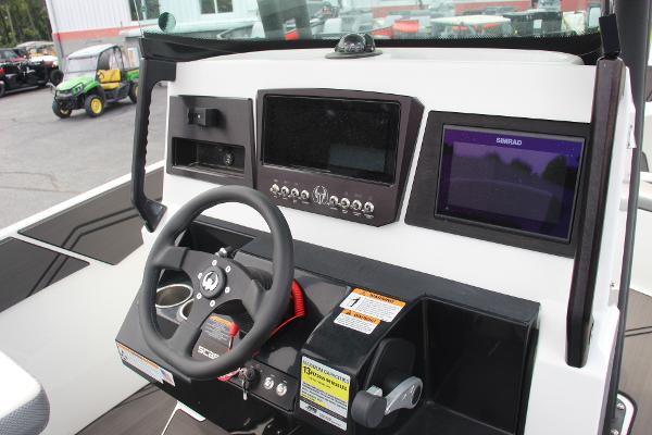 2023 Scarab 255 Open ID boat dashboard with steering wheel and navigation controls.