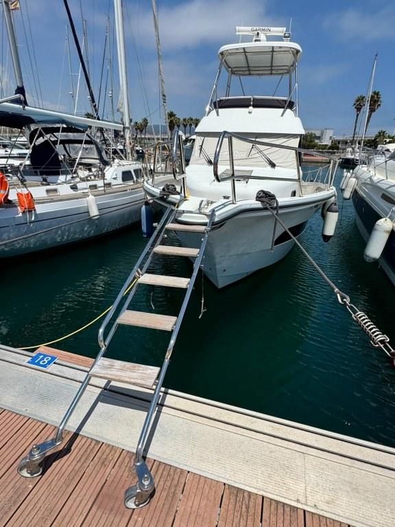 2022 Rodman 1290 Evolution yacht docked with boarding ladder.