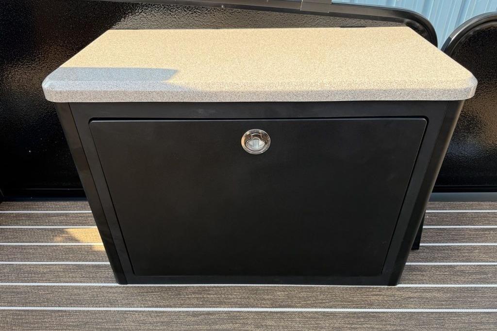 Black storage cabinet with beige countertop on Premier 250 Solaris RS CL, 2026 model.