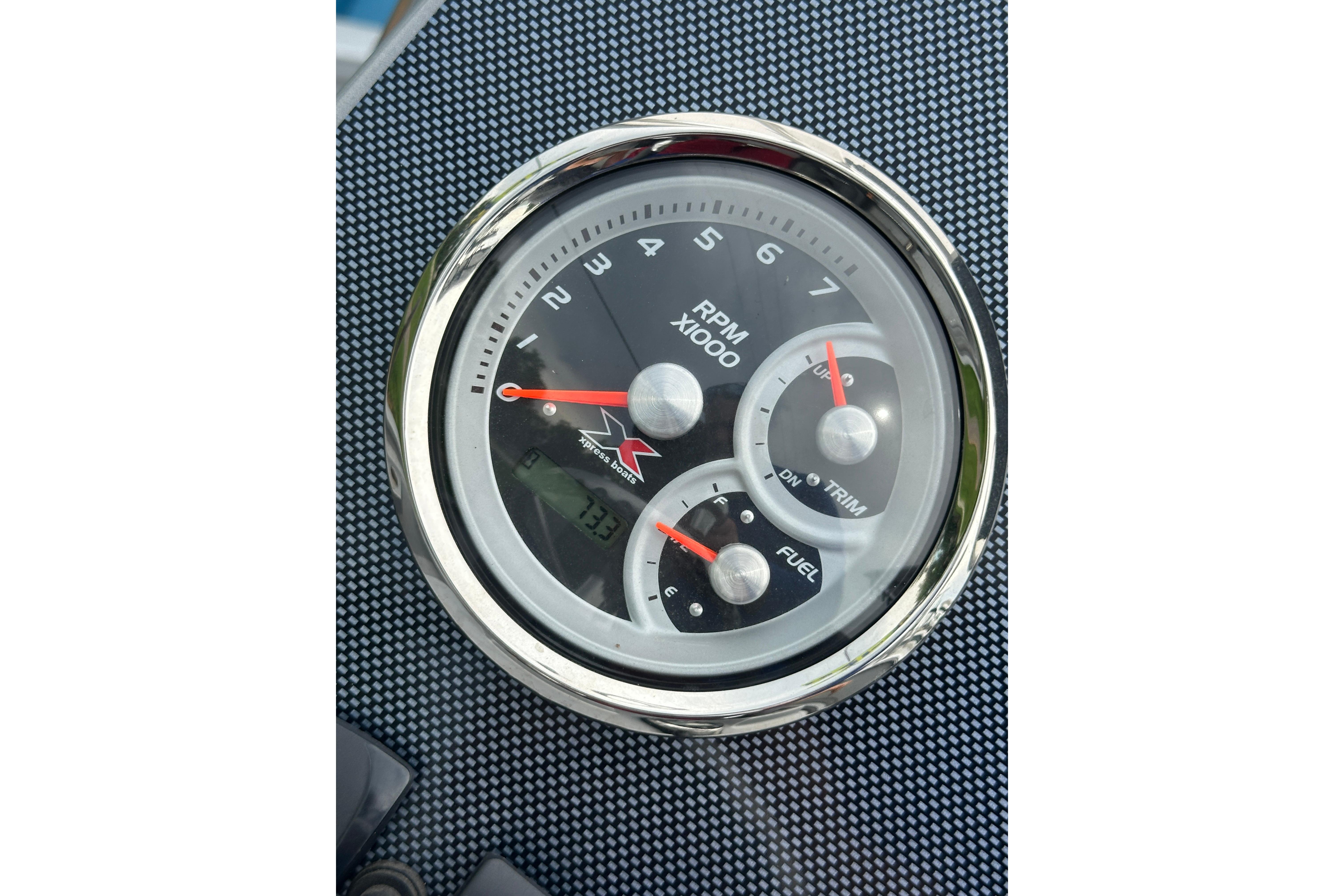 2024 Xpress H20B Bay boat dashboard with RPM, trim, and fuel gauges.