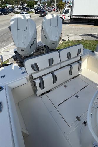 2024 ShearWater 270 SS Open Carolina boat with dual Mercury engines, docked in a marina.
