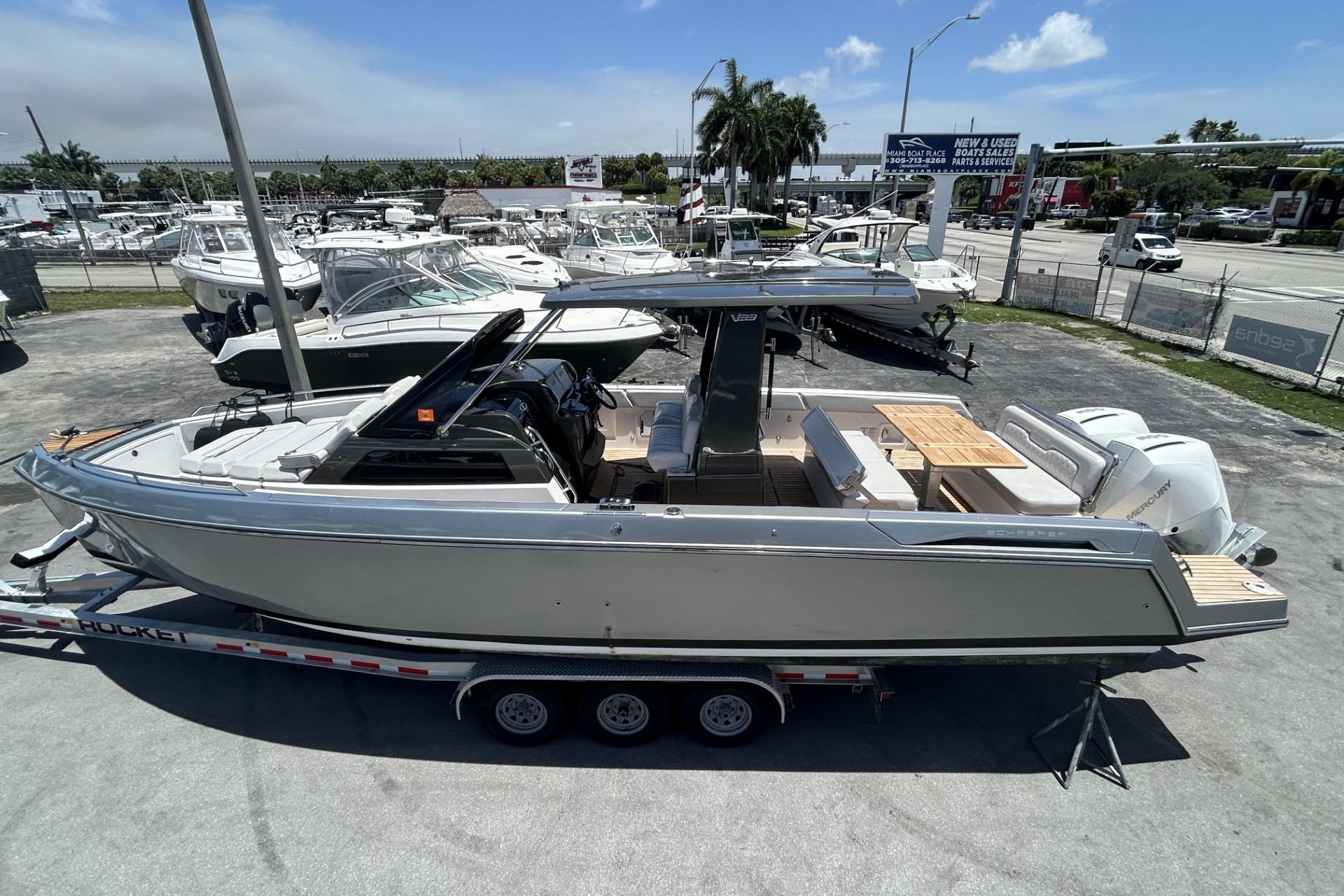 2023 Schaefer V33 boat on trailer, displayed outdoors at a dealership.