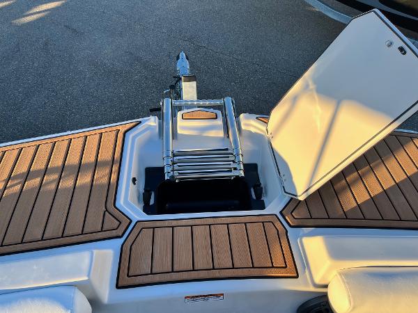 2024 Starcraft SVX 191 boat with open storage compartment and ladder.