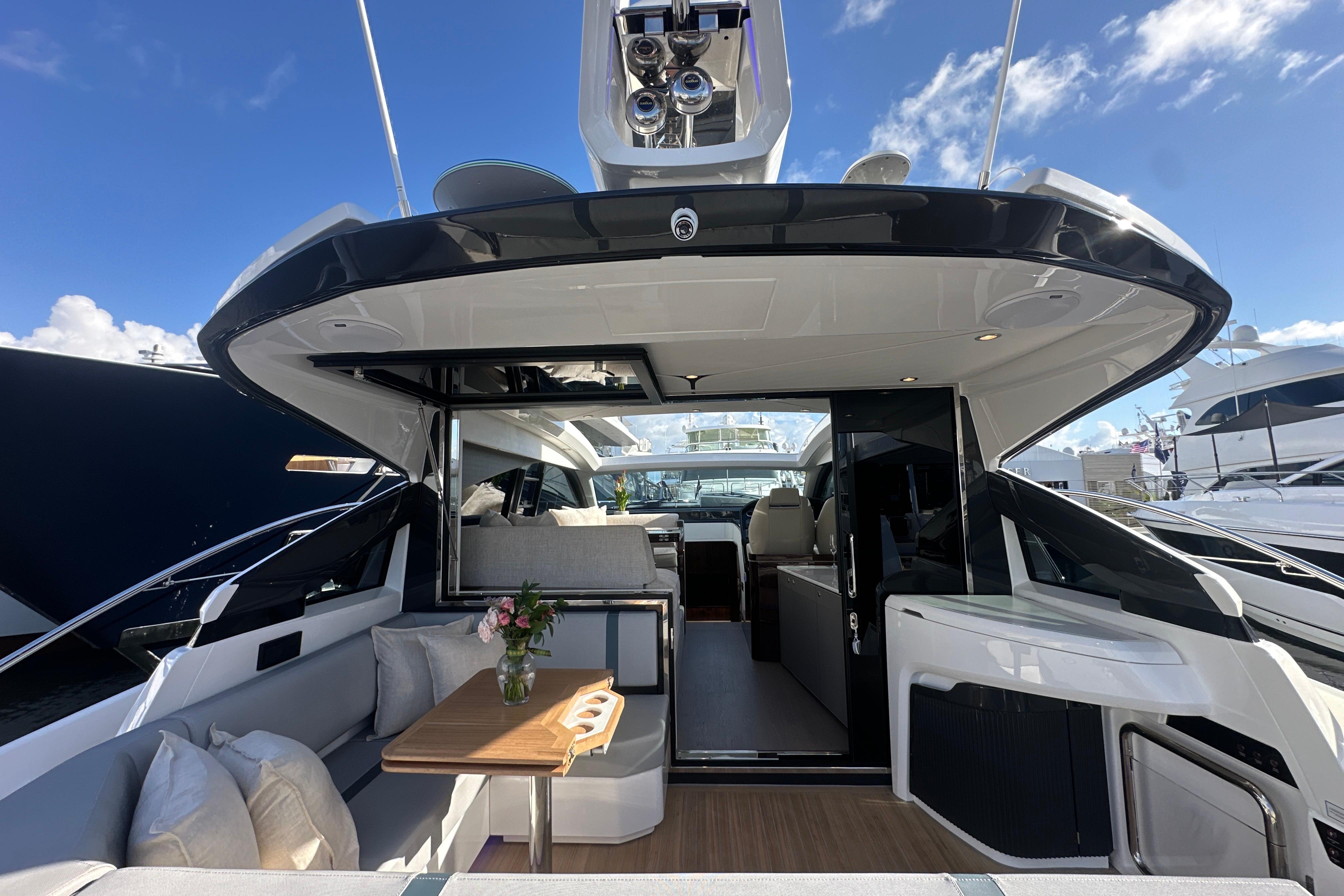 Luxurious 2026 Fairline Targa 47 GT yacht interior with elegant seating and table.