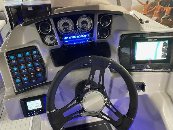 2022 Starcraft SLS-3Q DH boat dashboard with steering wheel, gauges, and navigation system.