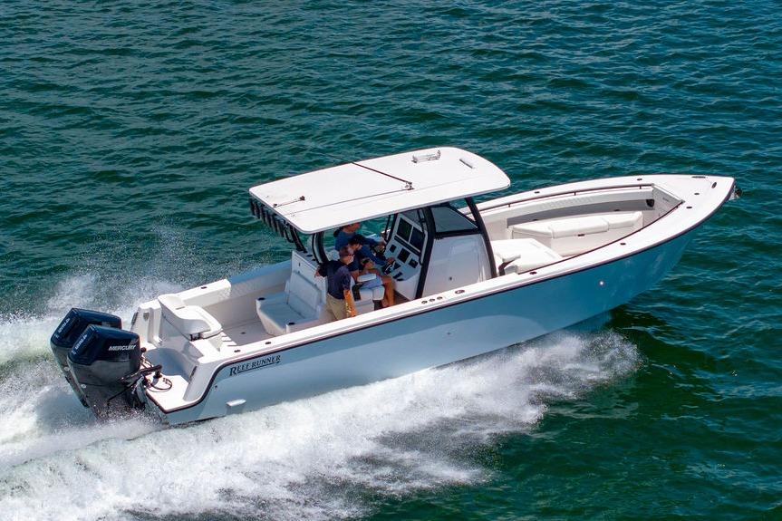 2027 Reef Runner 340 boat cruising on open water, showcasing sleek design and powerful performance.