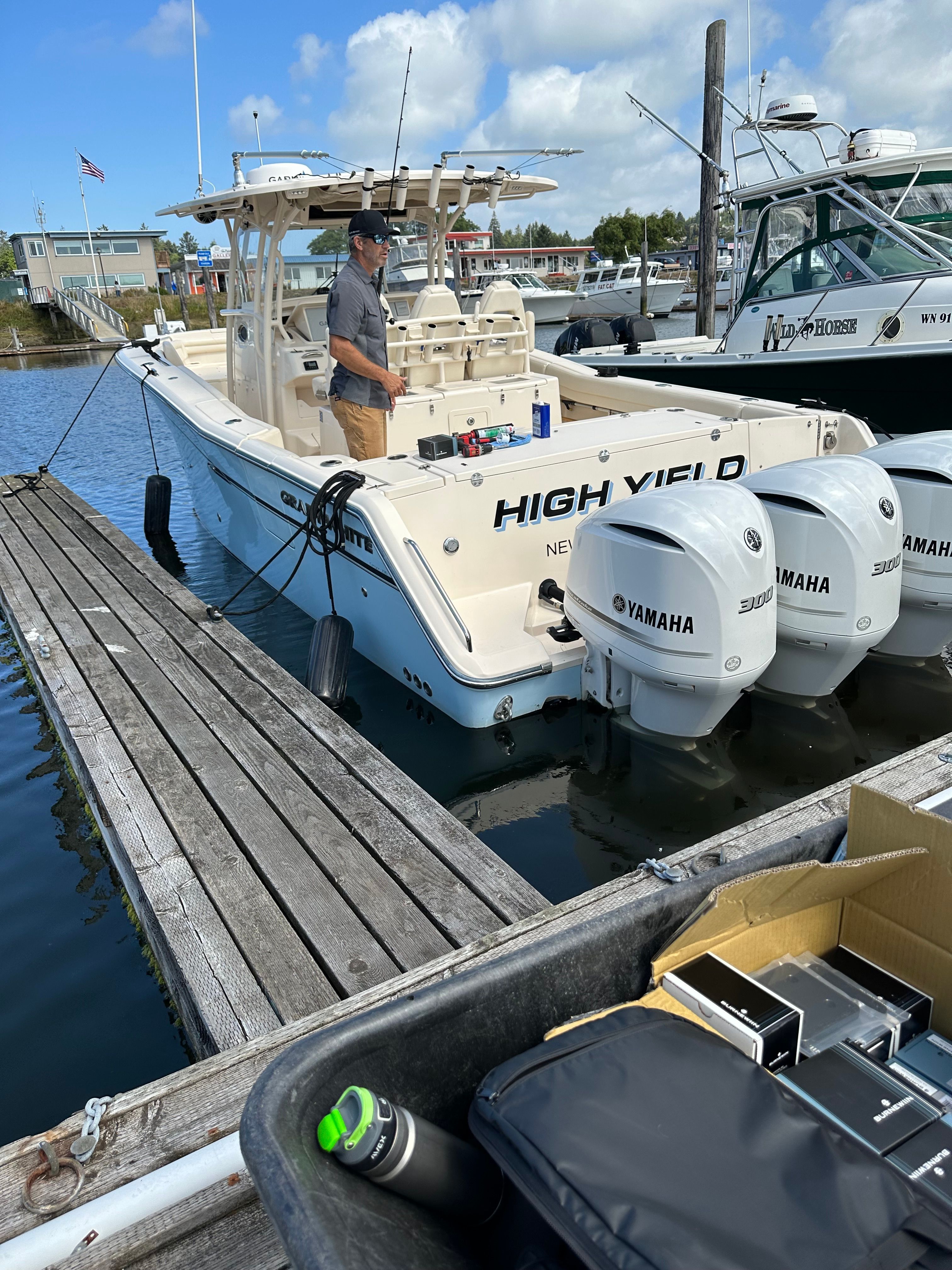 A 2019 Grady-White Canyon 336 boat docked, featuring three Yamaha engines.
