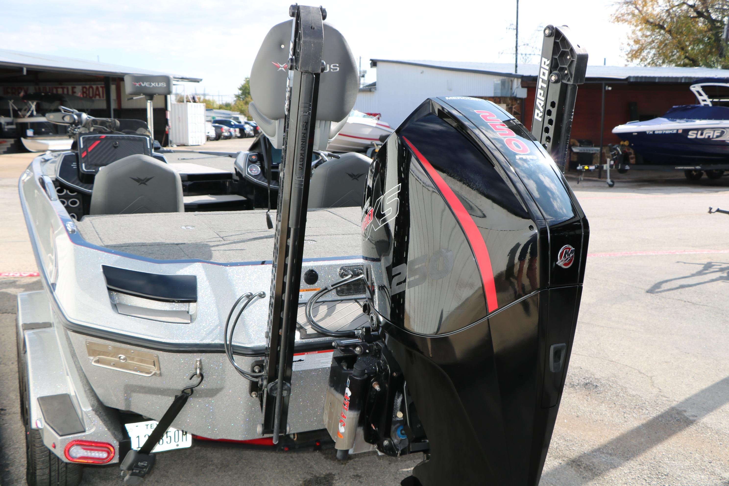 2022 Vexus VX21 boat with powerful outboard motor, parked outdoors.