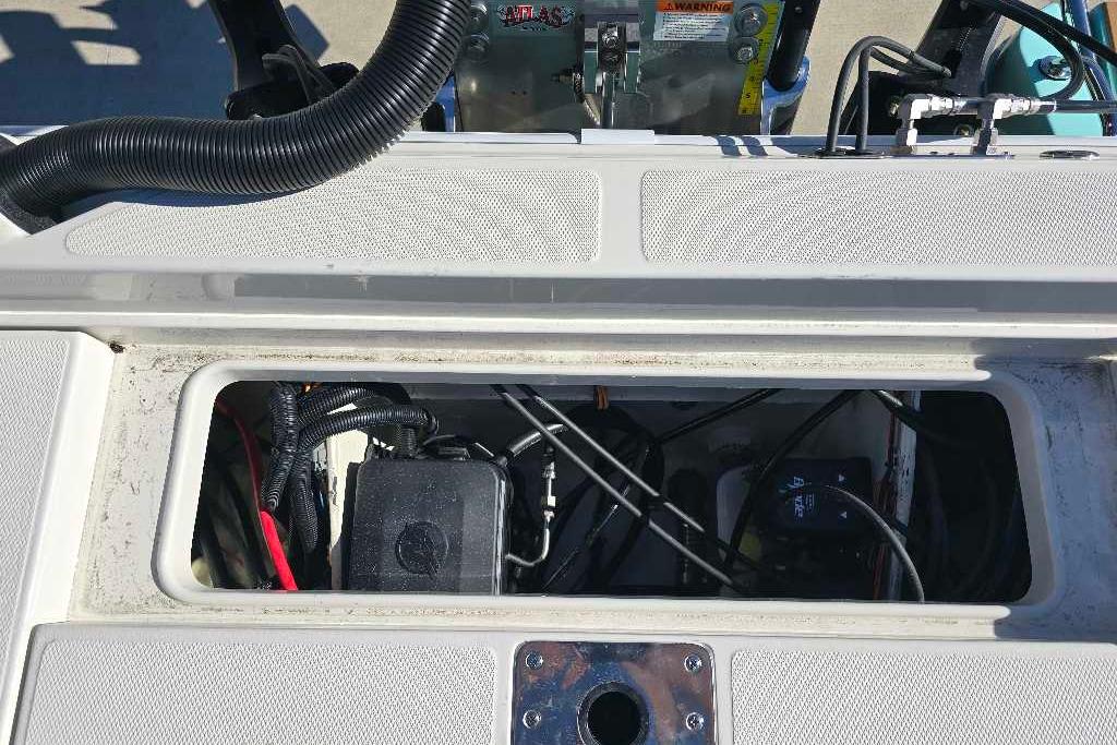 Open compartment of 2025 Ranger 2510 Bay boat showing wiring and components.