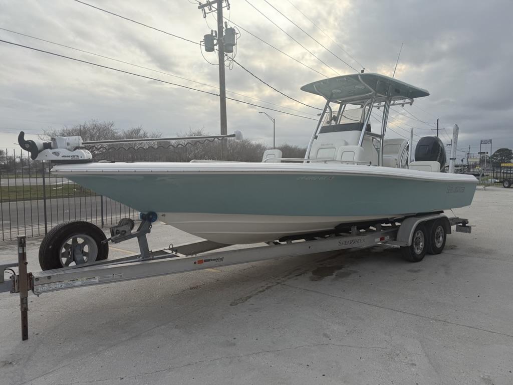 2017 ShearWater 270 Carolina Flare boat on trailer, overcast sky background.