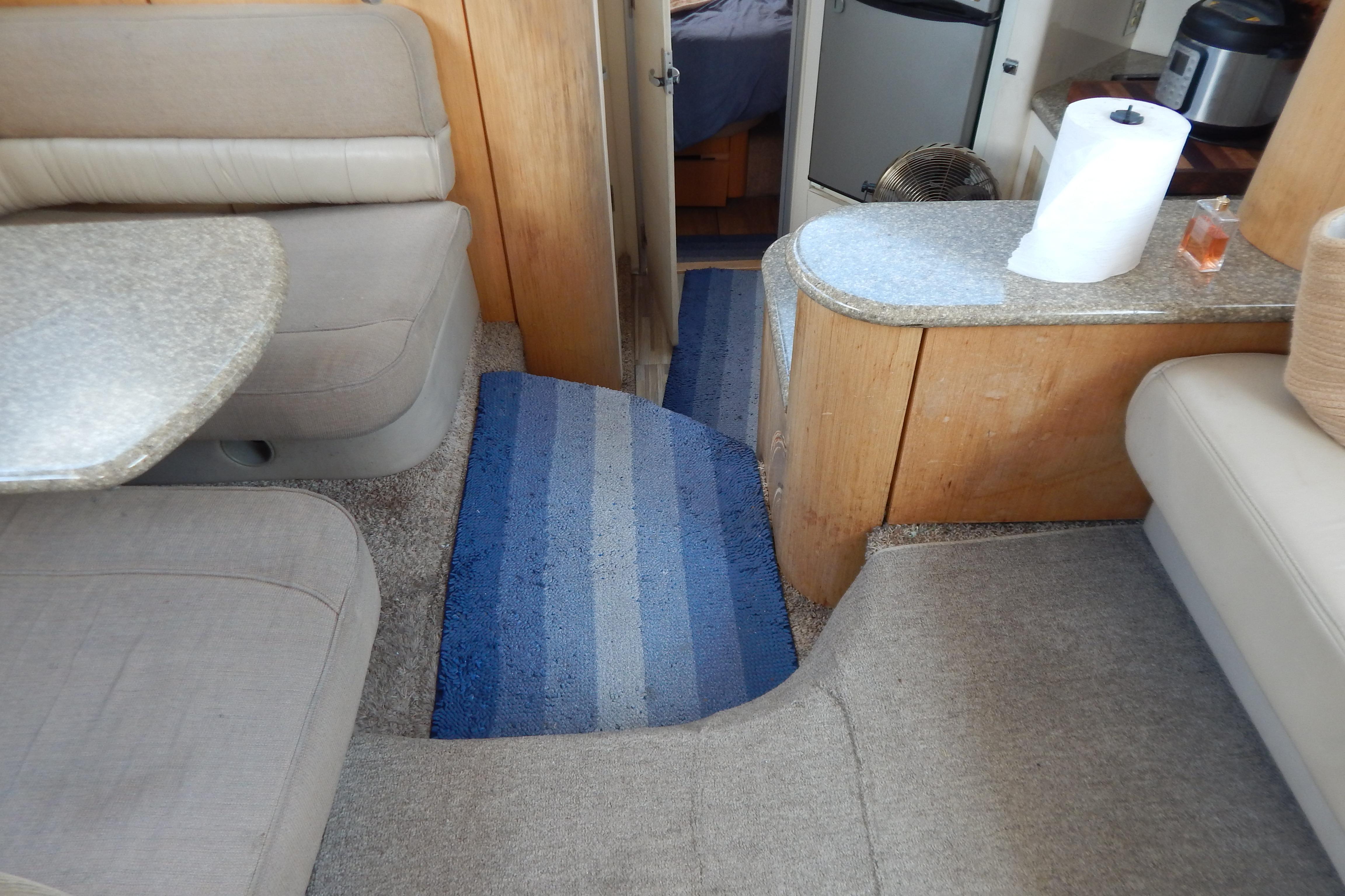 Interior of a 1998 Magnum 4100 SCR yacht with seating, table, and kitchenette.
