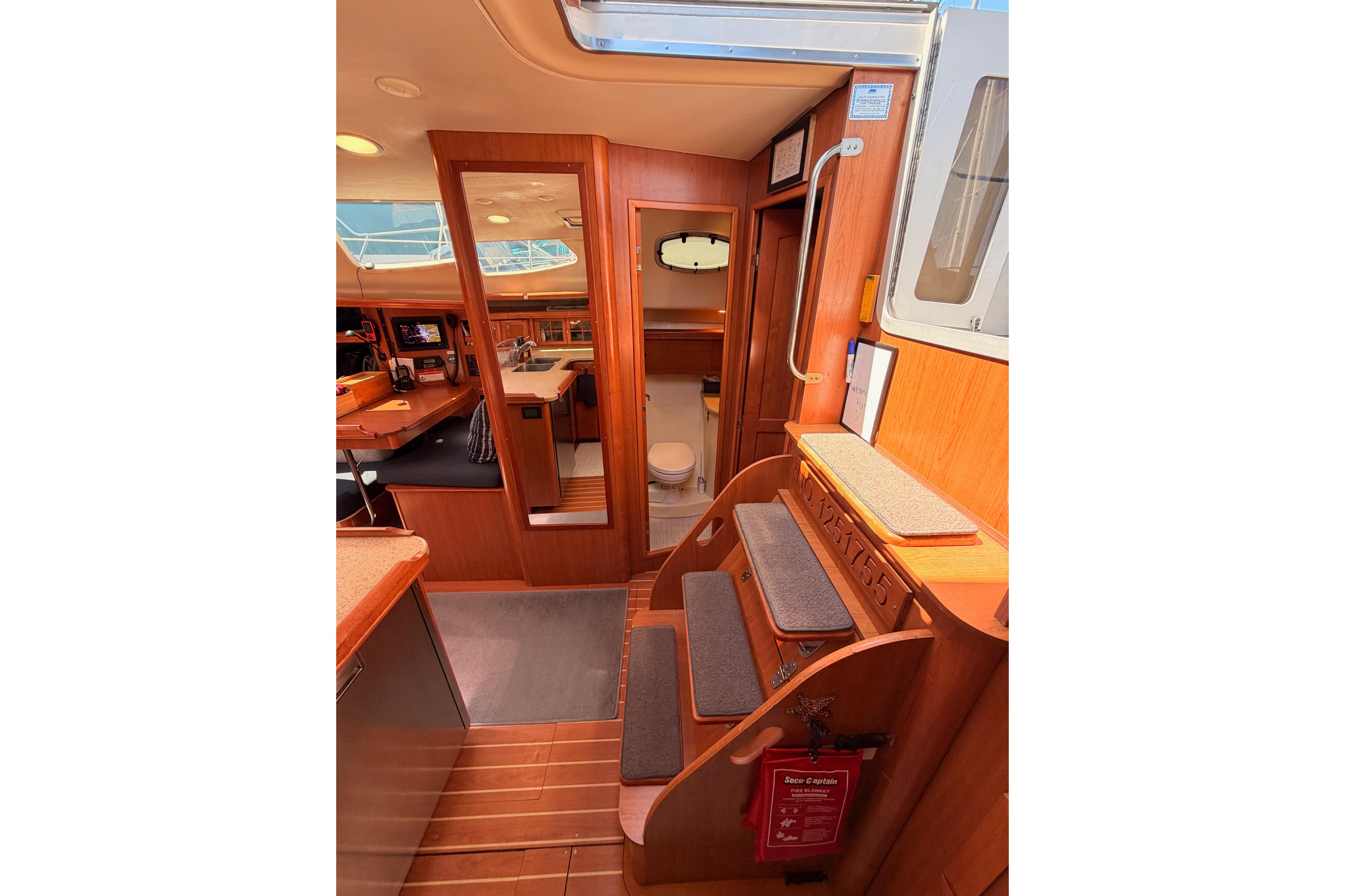 Interior of 2008 Hunter 45 Deck Salon yacht, featuring wooden finishes and cozy seating.