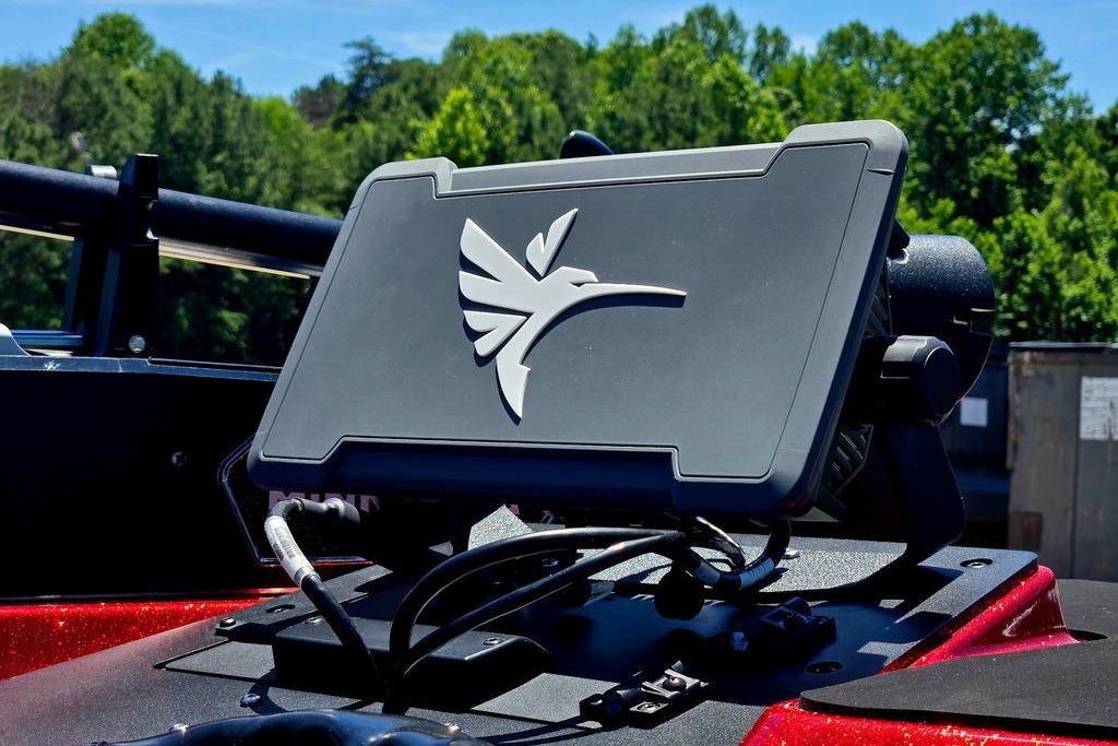 Skeeter ZXE20 2026 boat dashboard with electronic display, surrounded by lush greenery.