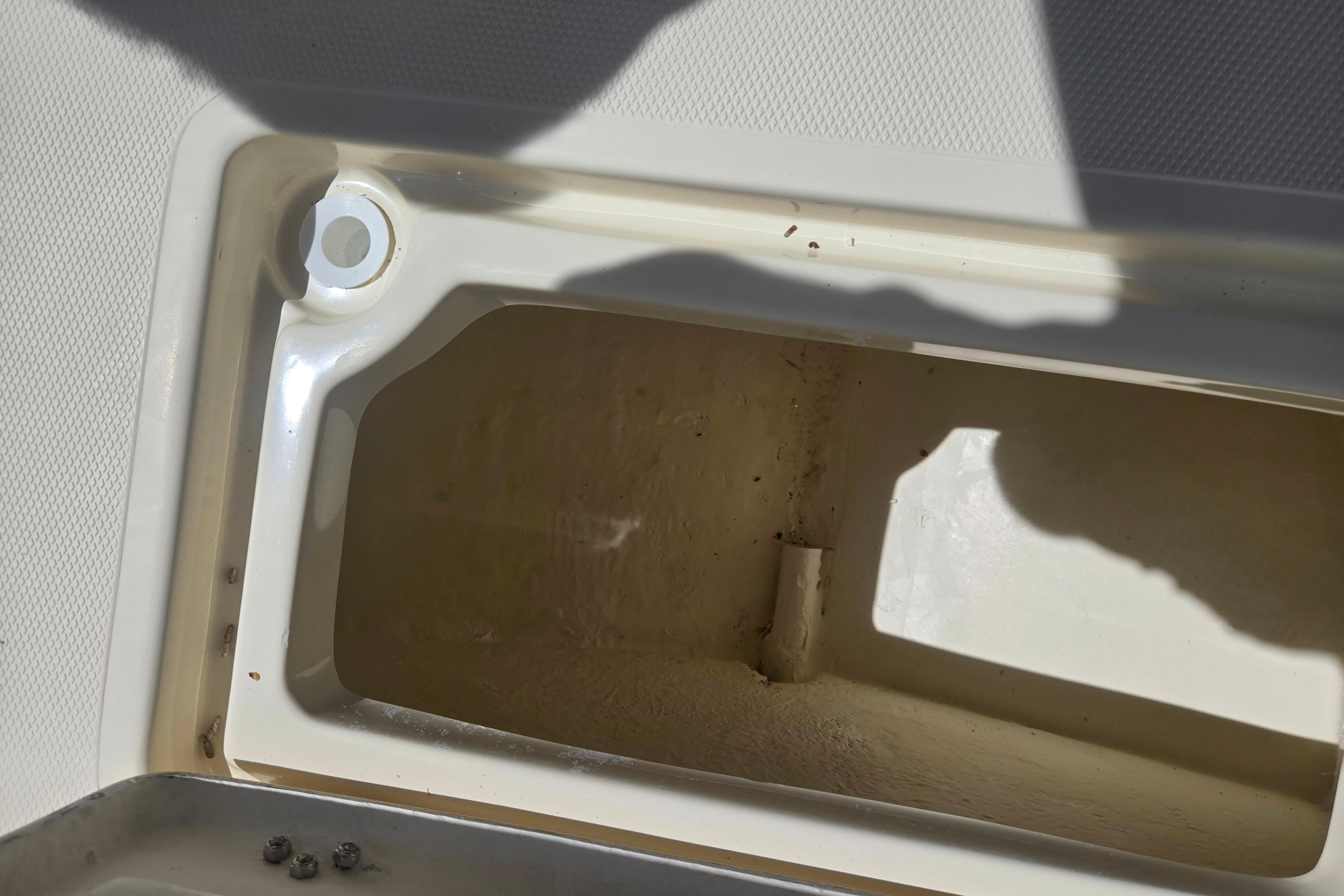 Storage compartment of a 2016 Key Largo 2000CC boat, showing interior details.