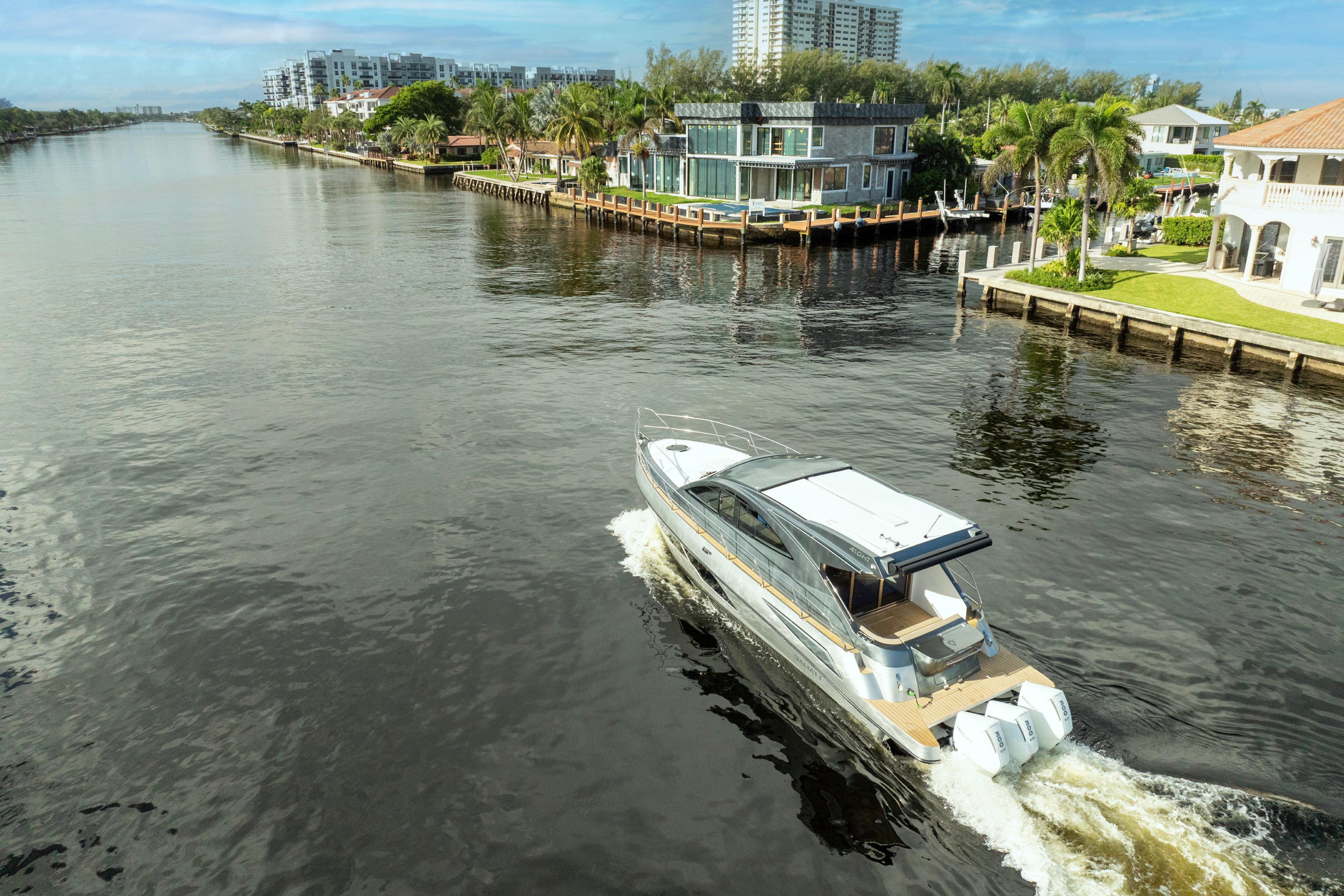 Luxury Valiatt 410HT yacht cruising a scenic canal, 2025 model.