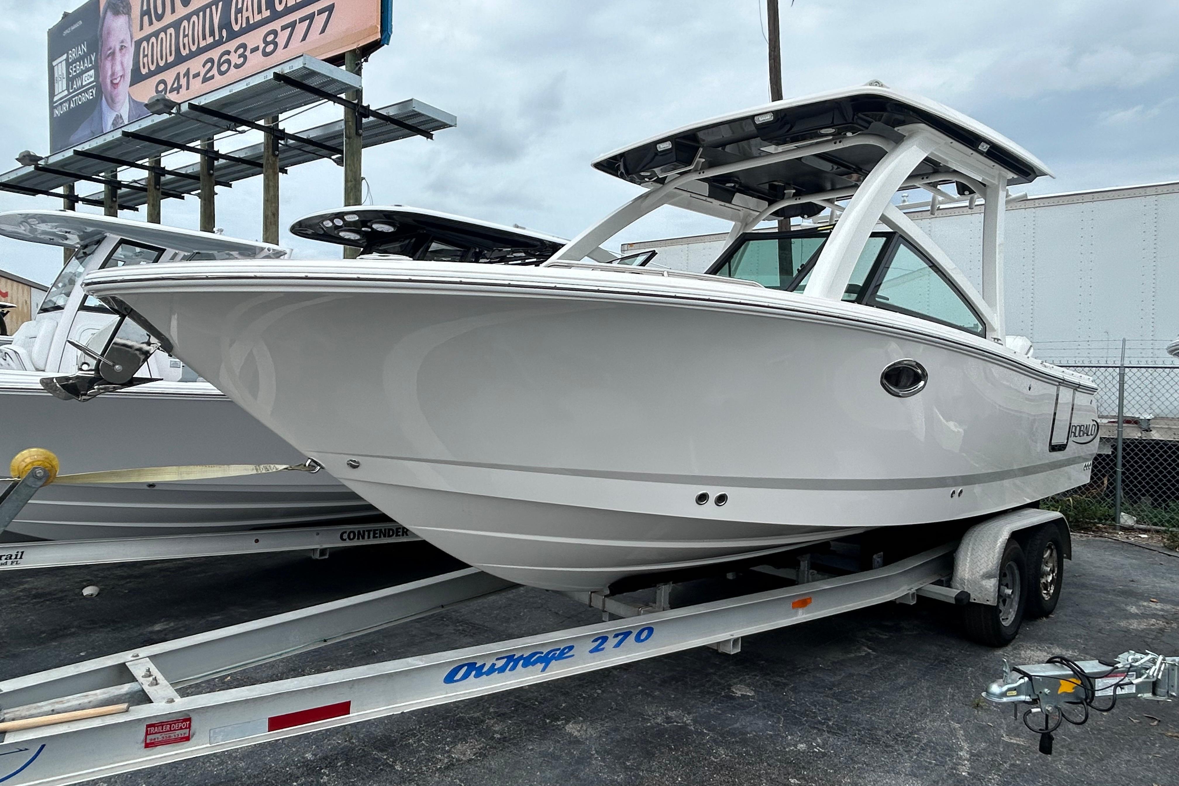 2026 Robalo R257 Dual Console boat on trailer, parked outdoors.