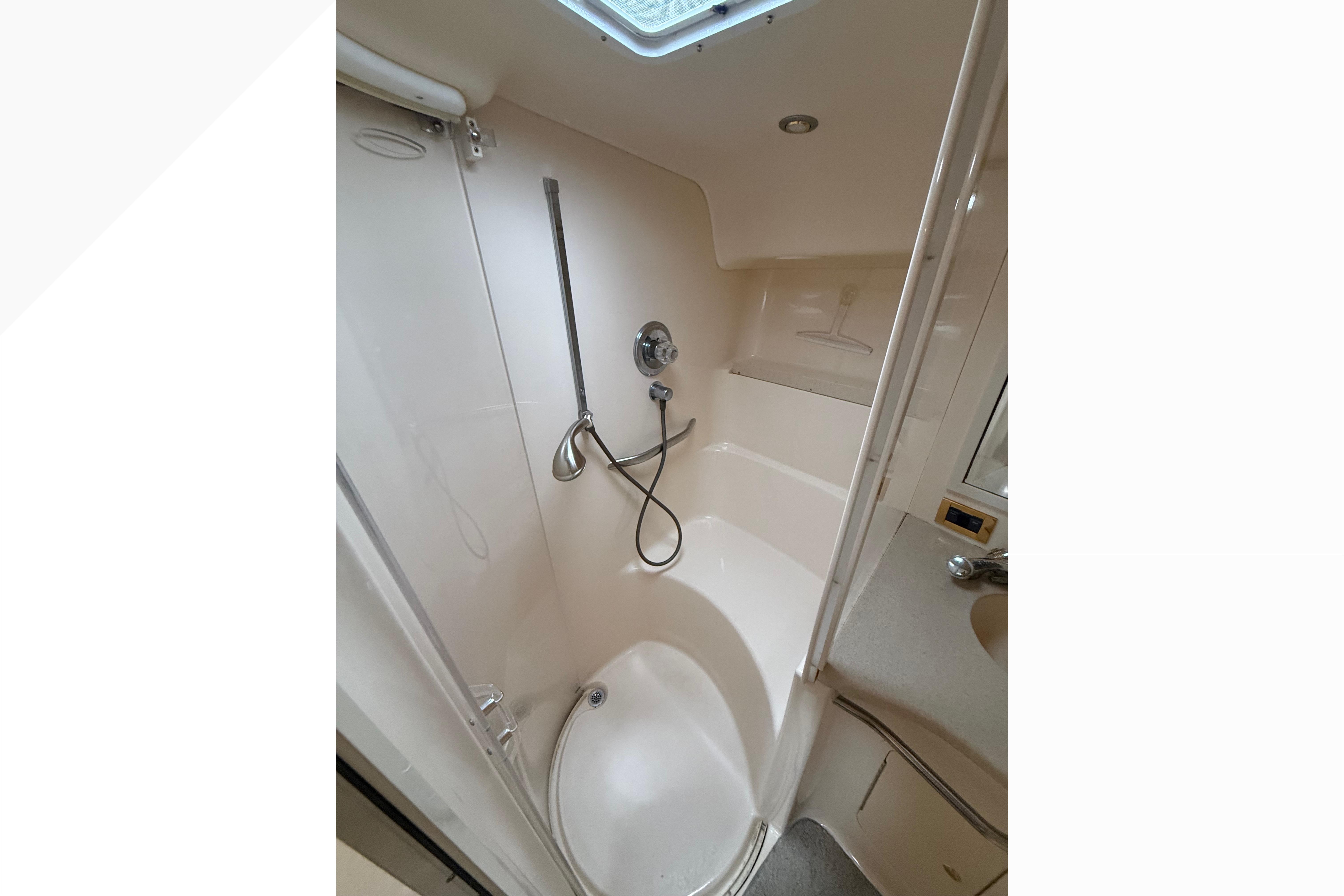 Bathroom interior of 1998 Sea Ray Sundancer 400 yacht, featuring shower and sink.