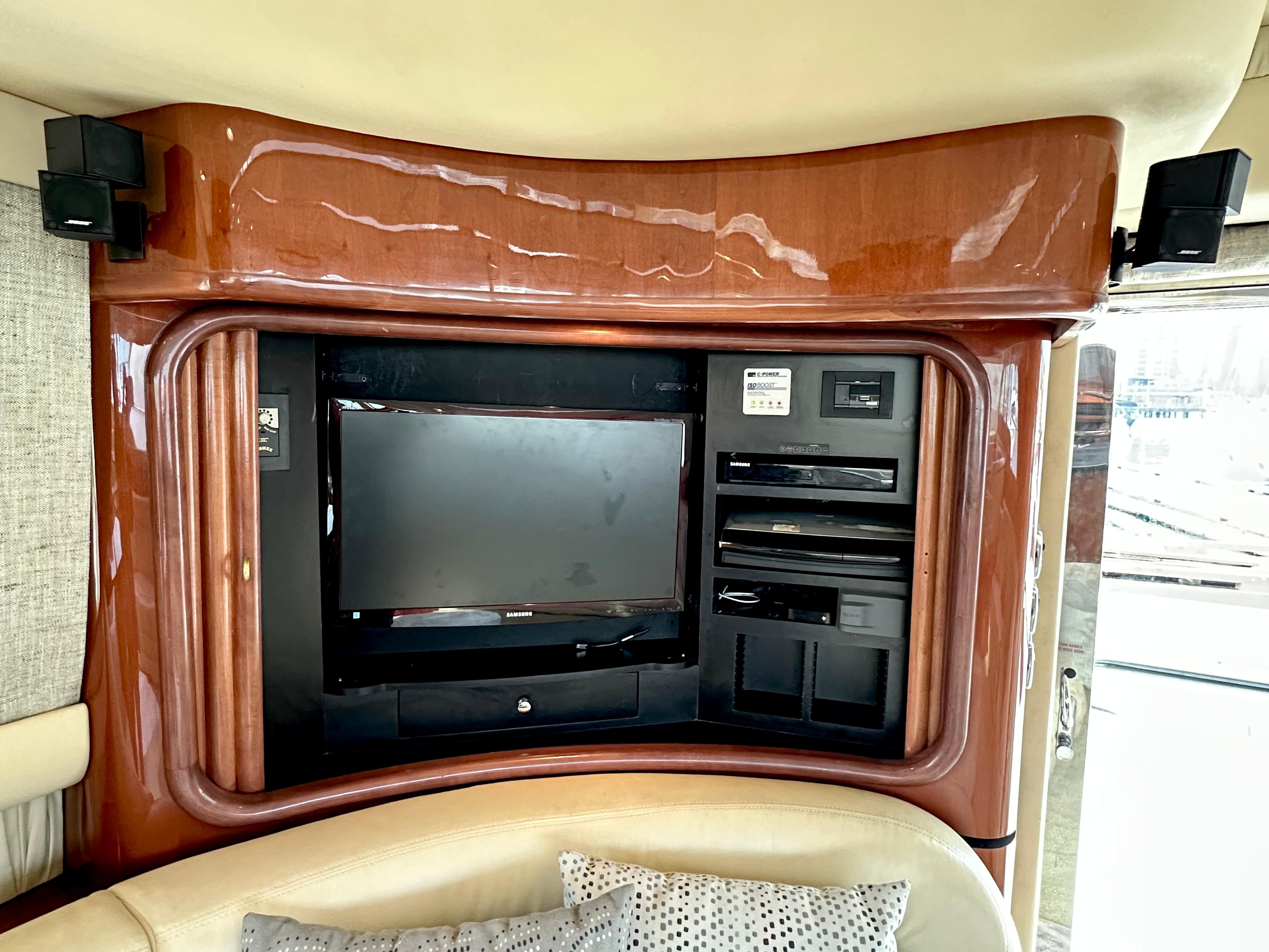 Interior entertainment system on 2002 Sea Ray 560 Sedan Bridge yacht, featuring a TV and audio equipment.