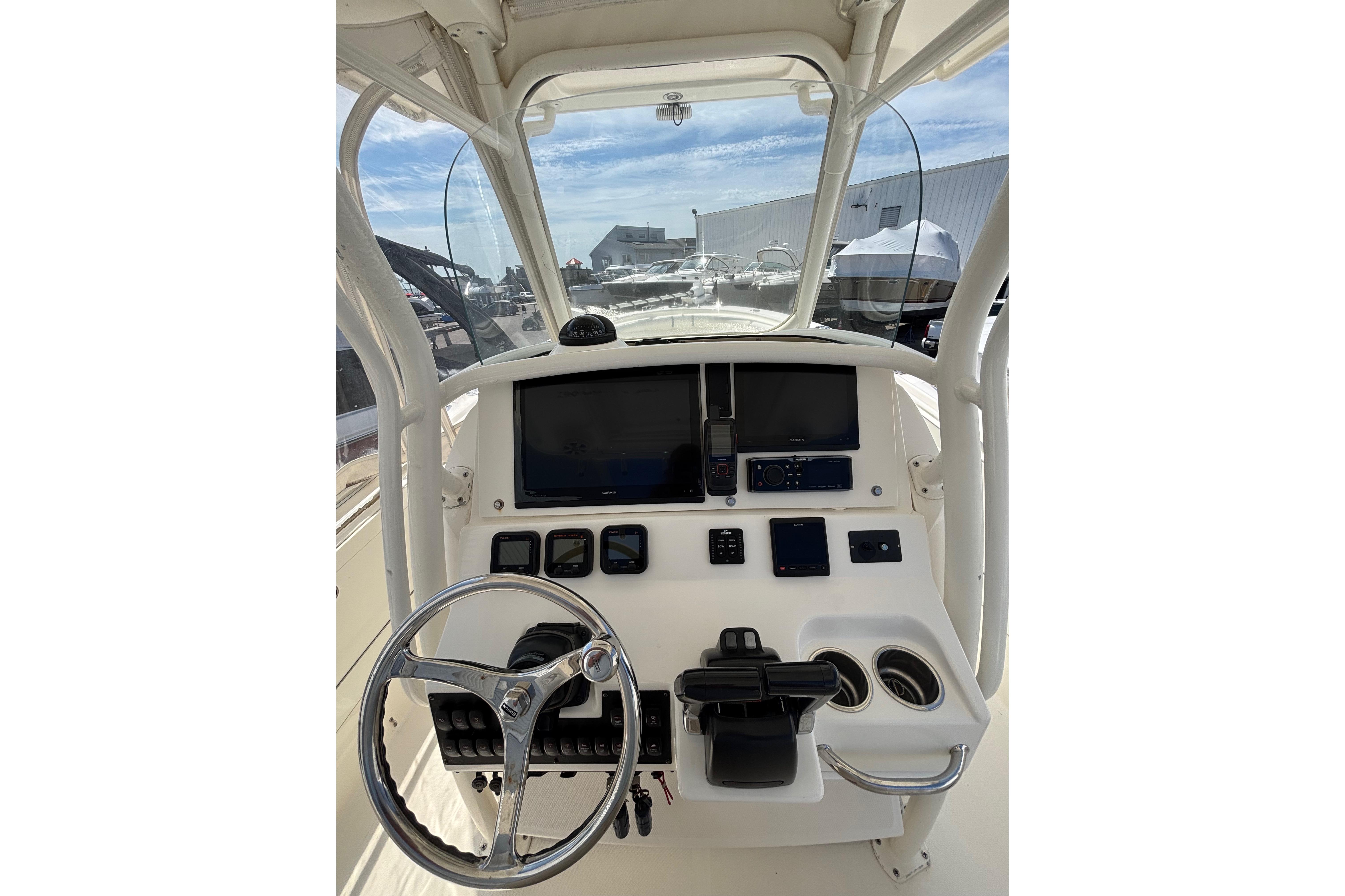 2006 Edgewater 318CC boat dashboard with steering wheel and navigation controls.
