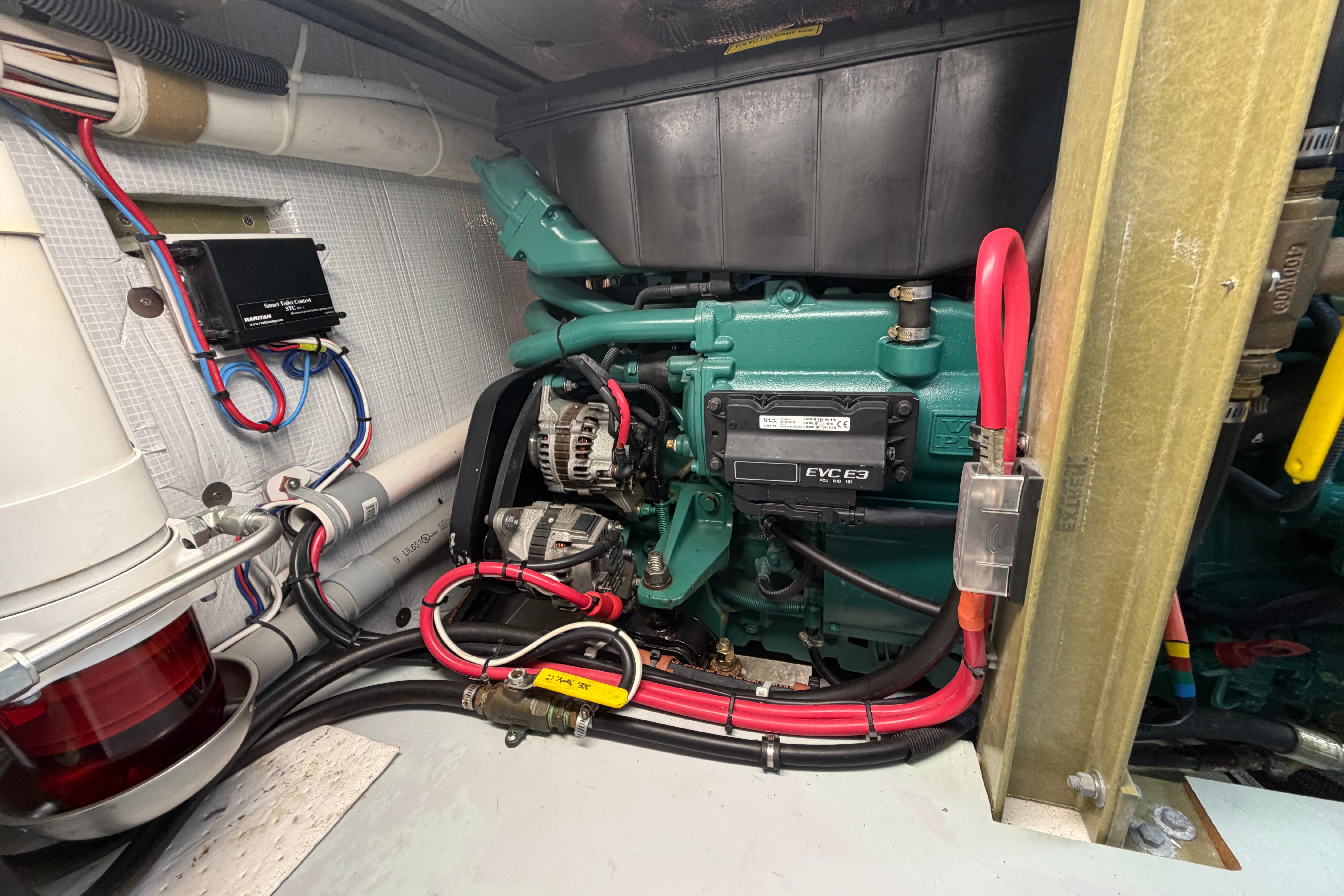 Engine compartment of a 2018 H&H Marine Osmond Beal boat, showcasing wiring and components.