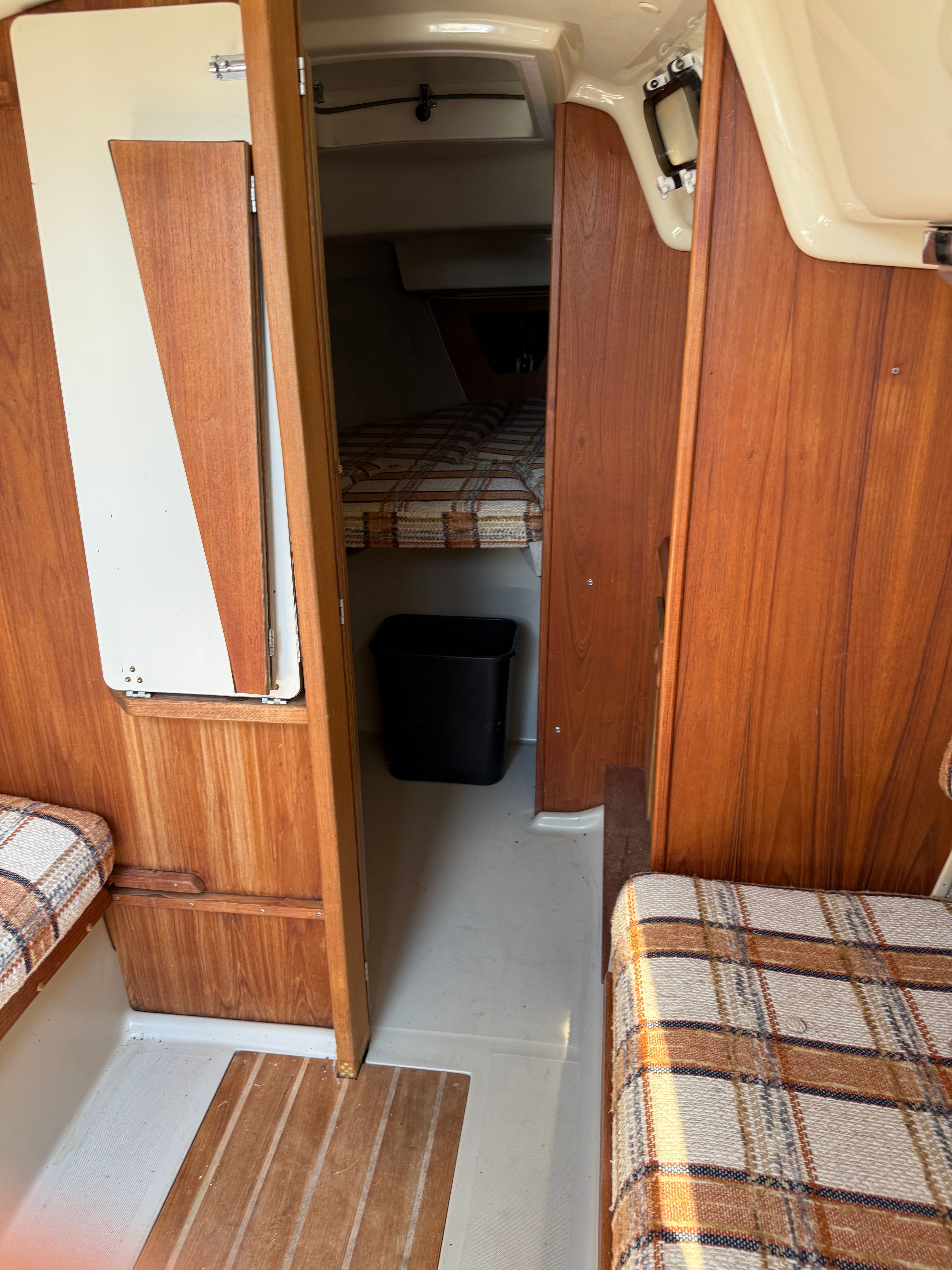 Interior of a 1984 O'Day 25 yacht with wood paneling.