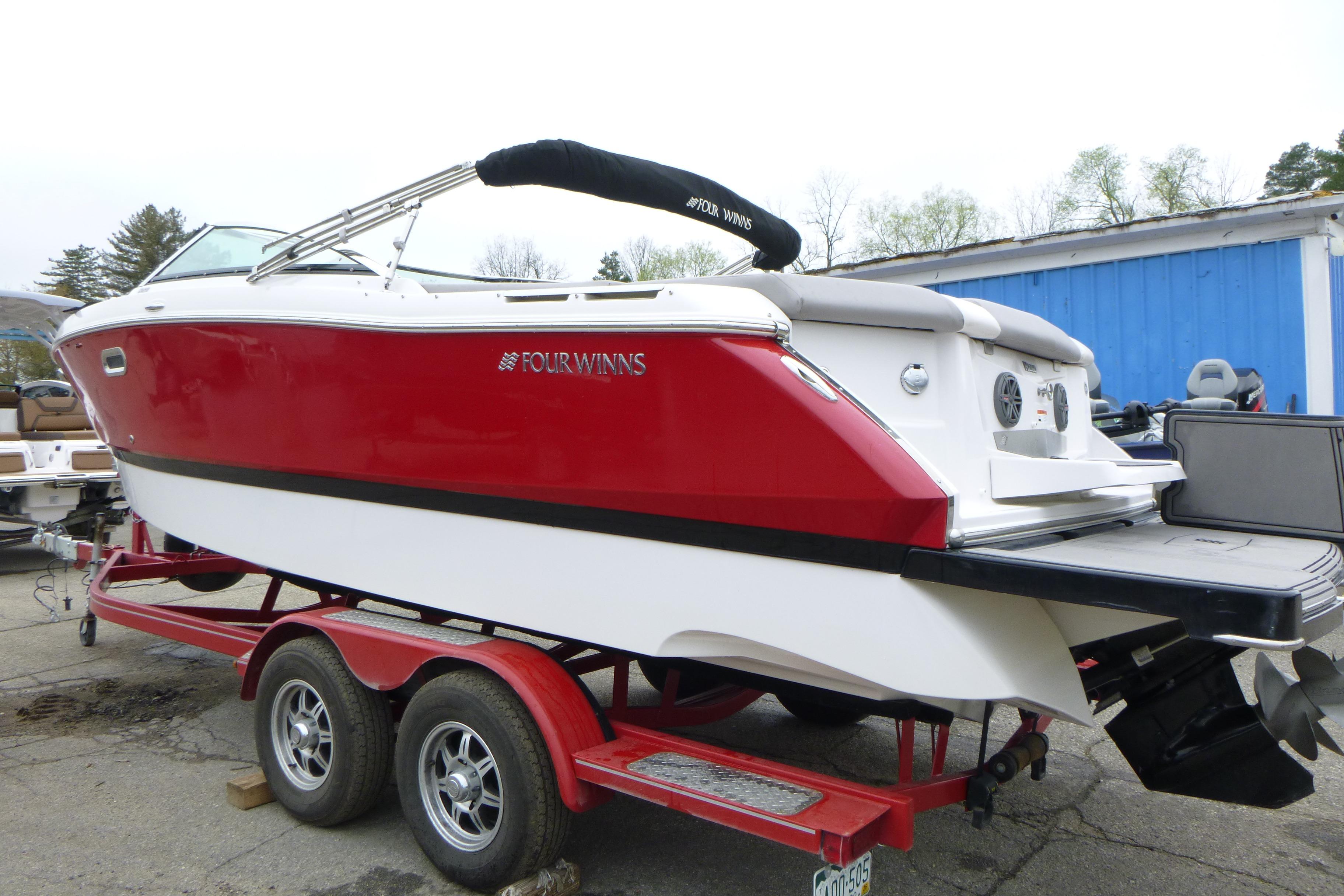 2017 Four Winns H260 boat in red and white on a trailer.