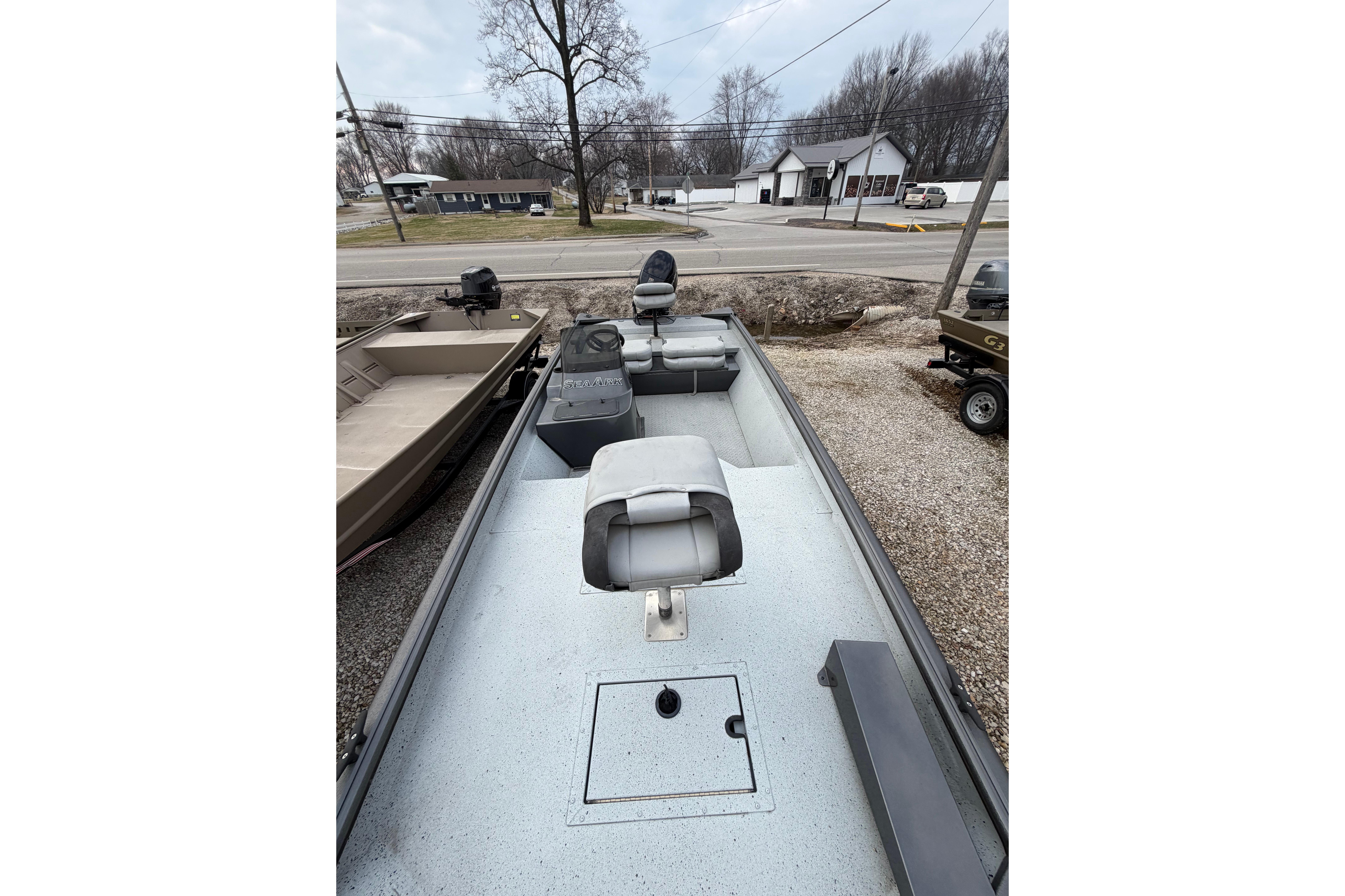 2023 SeaArk 180 RX boat with seating, parked outdoors on gravel.