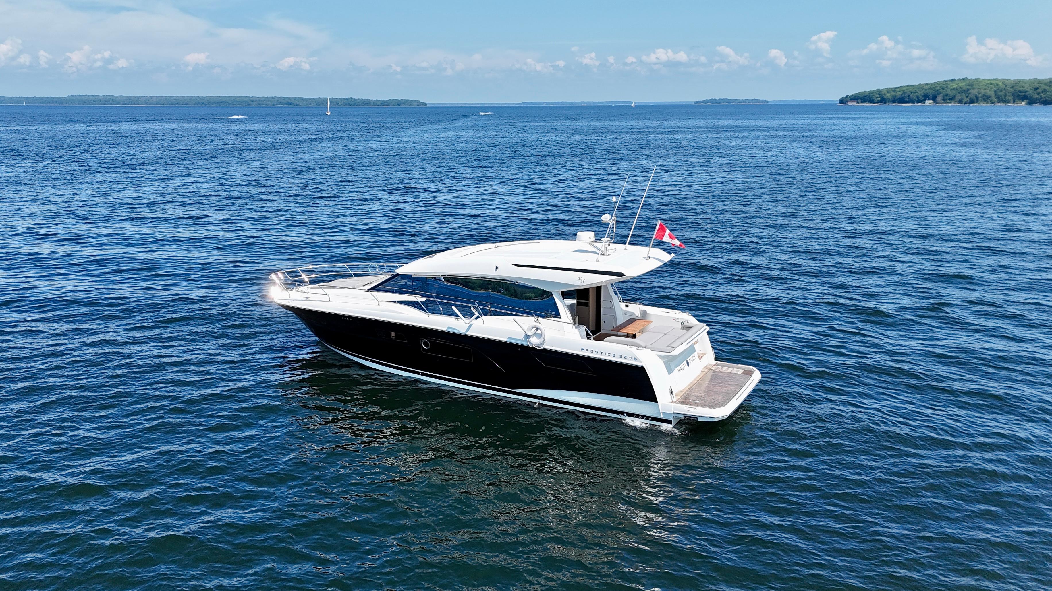 2023 Prestige 520S yacht cruising on a serene blue ocean.