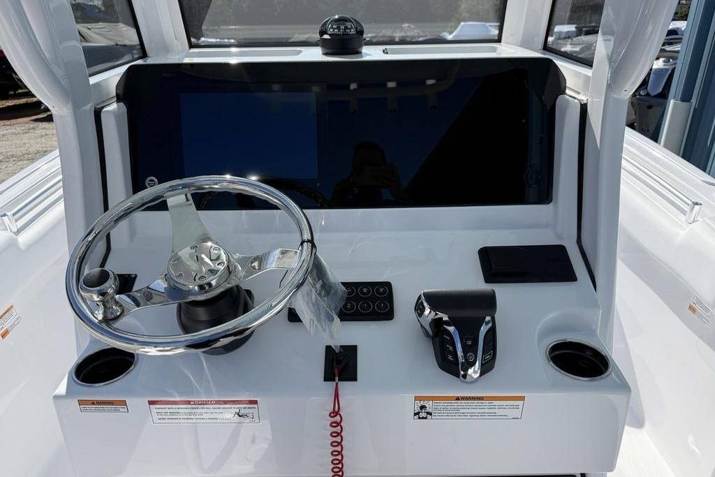 2026 Sportsman Open 232 Center Console dashboard with steering wheel and controls.