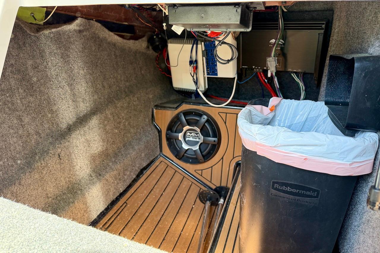 Interior of 2014 Nautique Super Air Nautique G21 with audio system and trash bin.