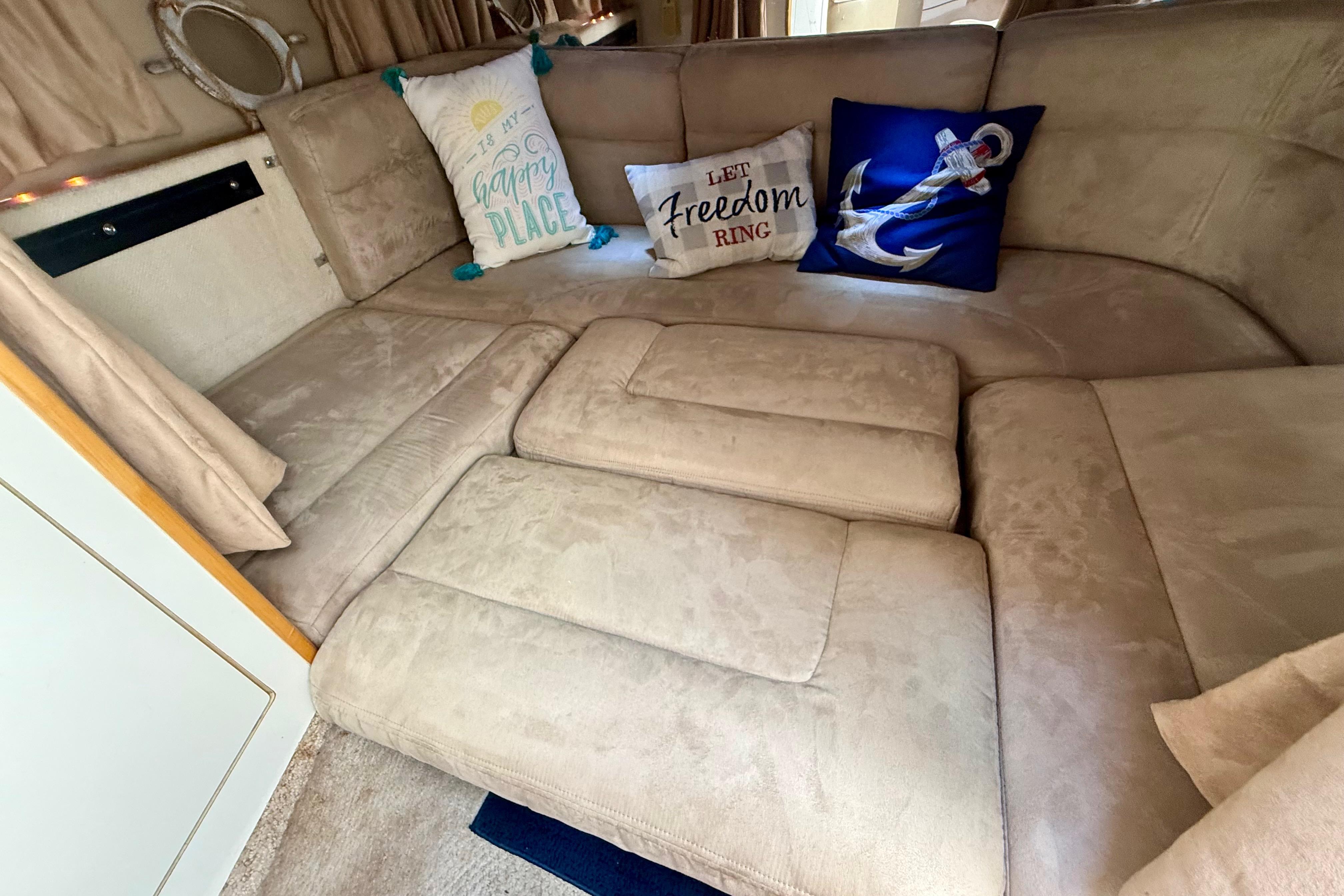 Interior of 1999 Chaparral Signature 300 with cozy seating and decorative pillows.