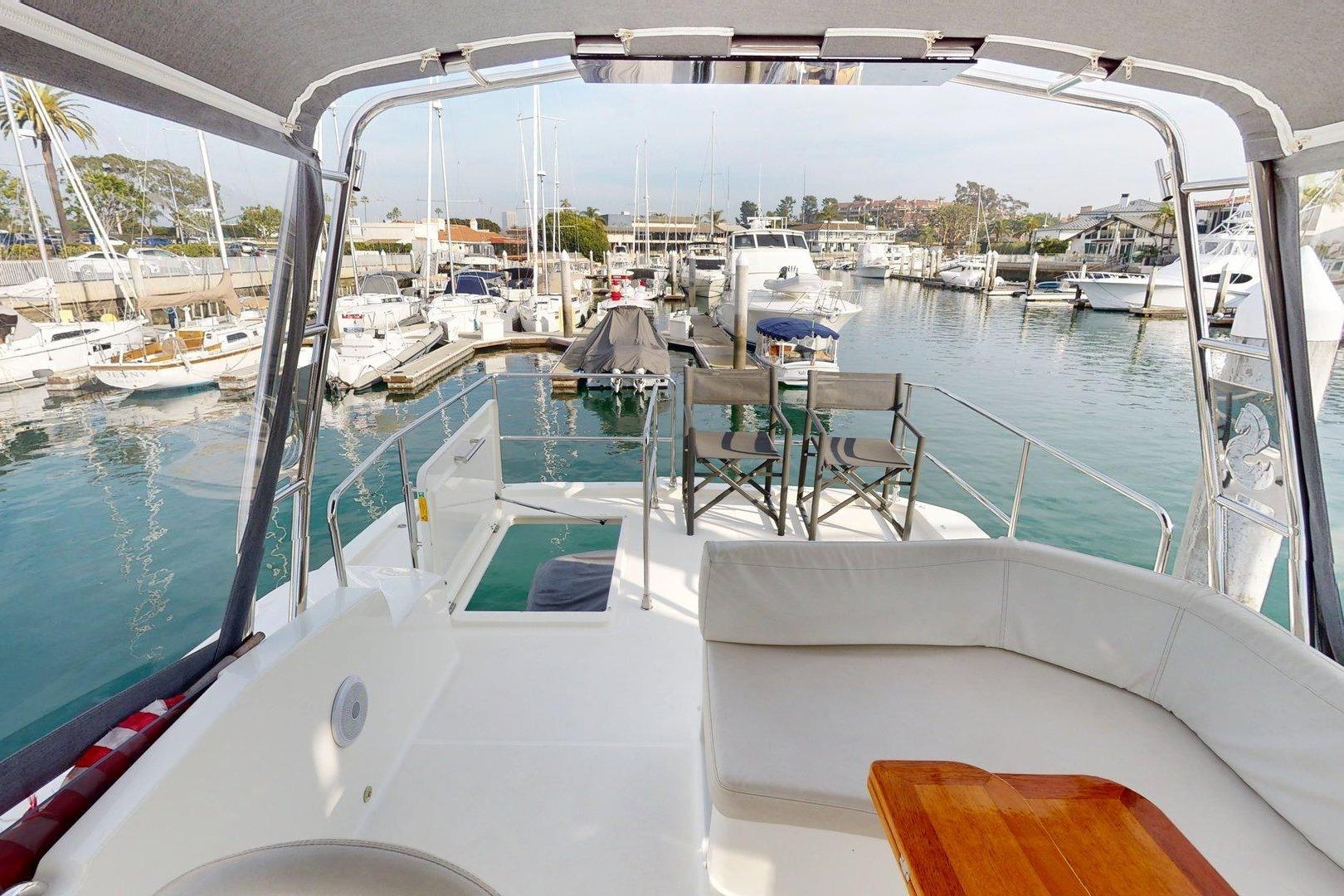 Beneteau Swift Trawler 35, 2021 model, docked in a marina with seating area.