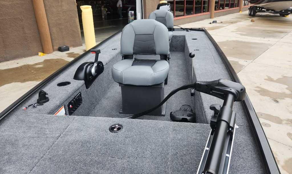2025 Tracker Panfish 17 boat interior with gray seating and control panel.
