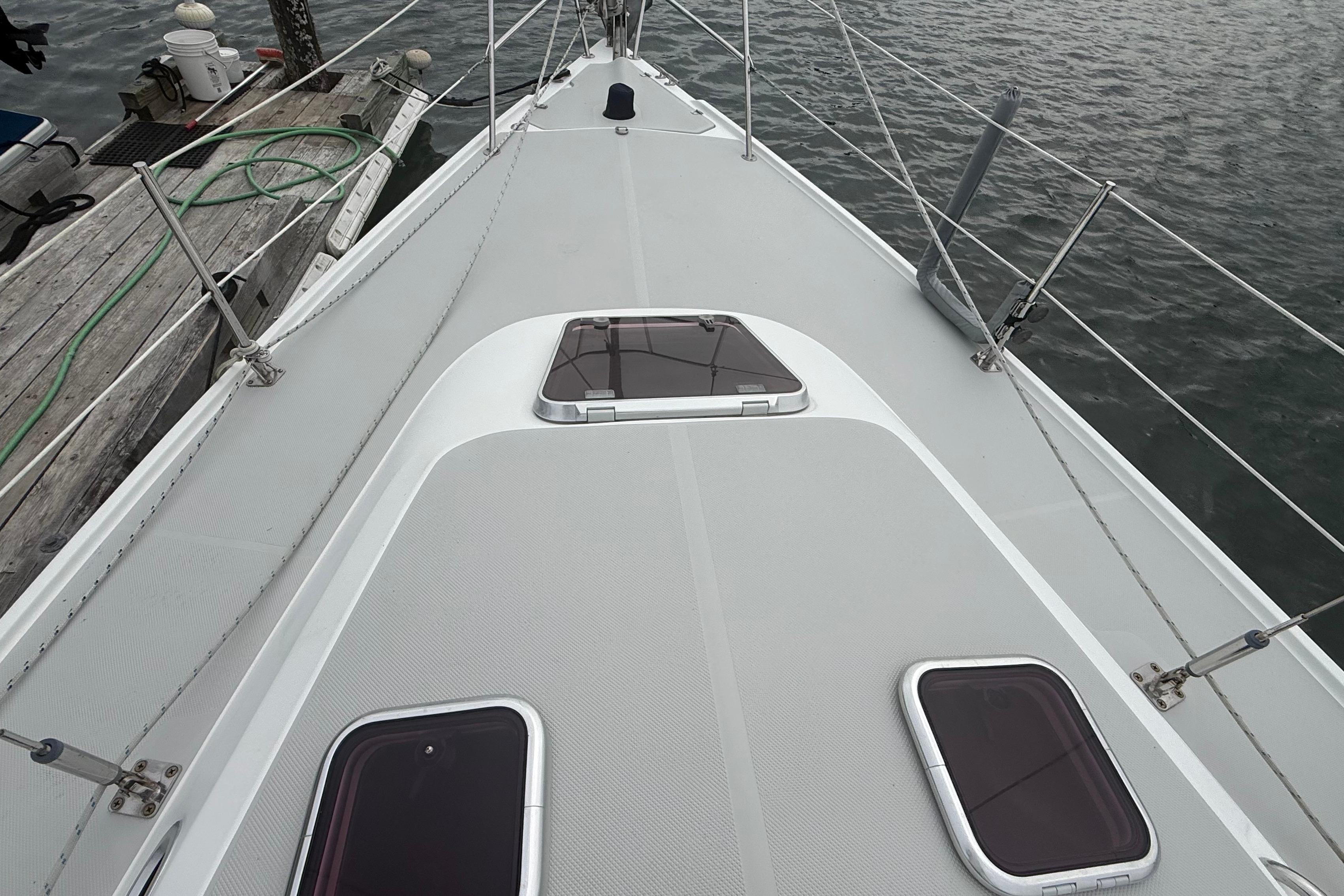 Deck view of a 2005 Catalina 36 MkII sailboat docked by the water.