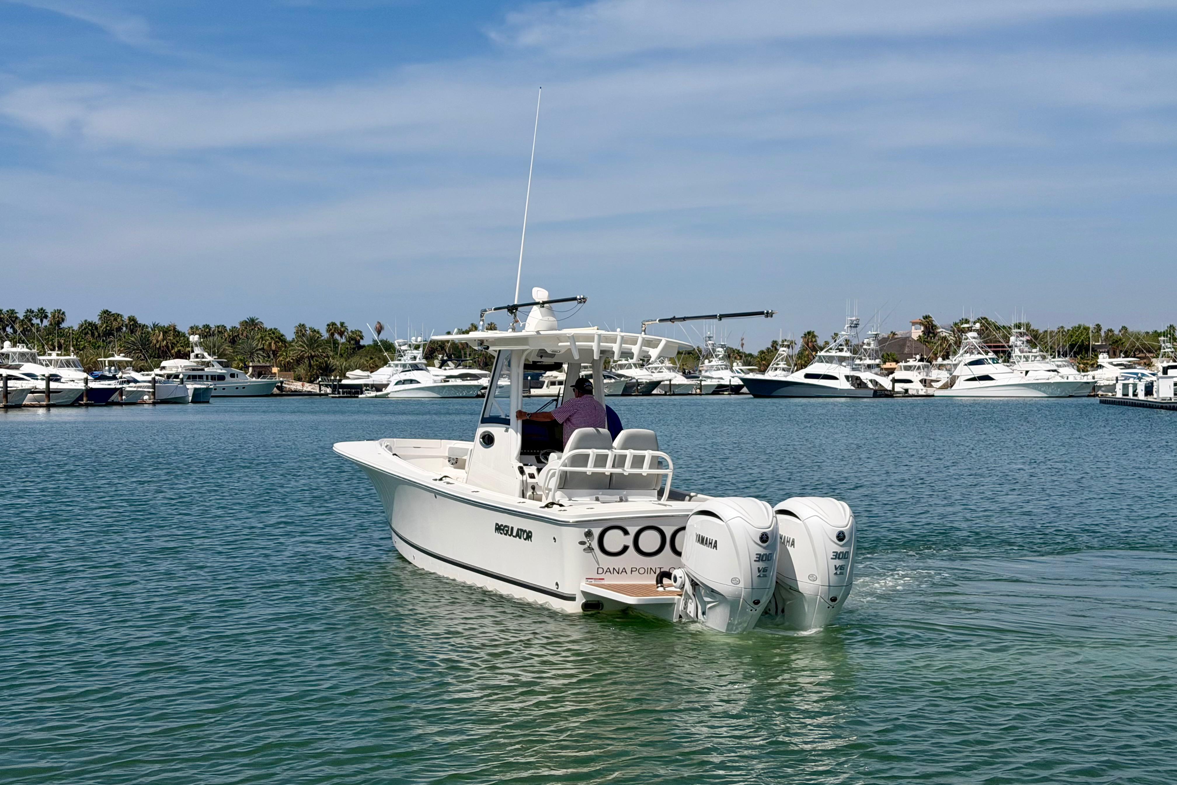 2022 Regulator 28 boat with twin Yamaha engines in a marina setting.
