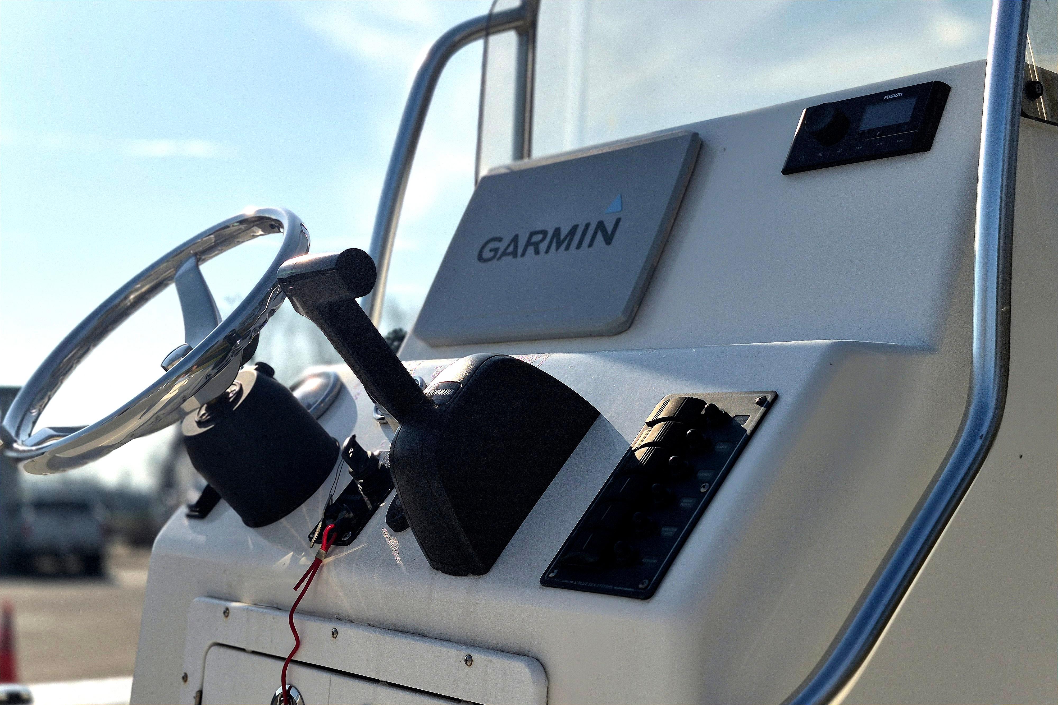 2024 May-Craft 22 Hancock Skiff dashboard with Garmin navigation system and steering wheel.