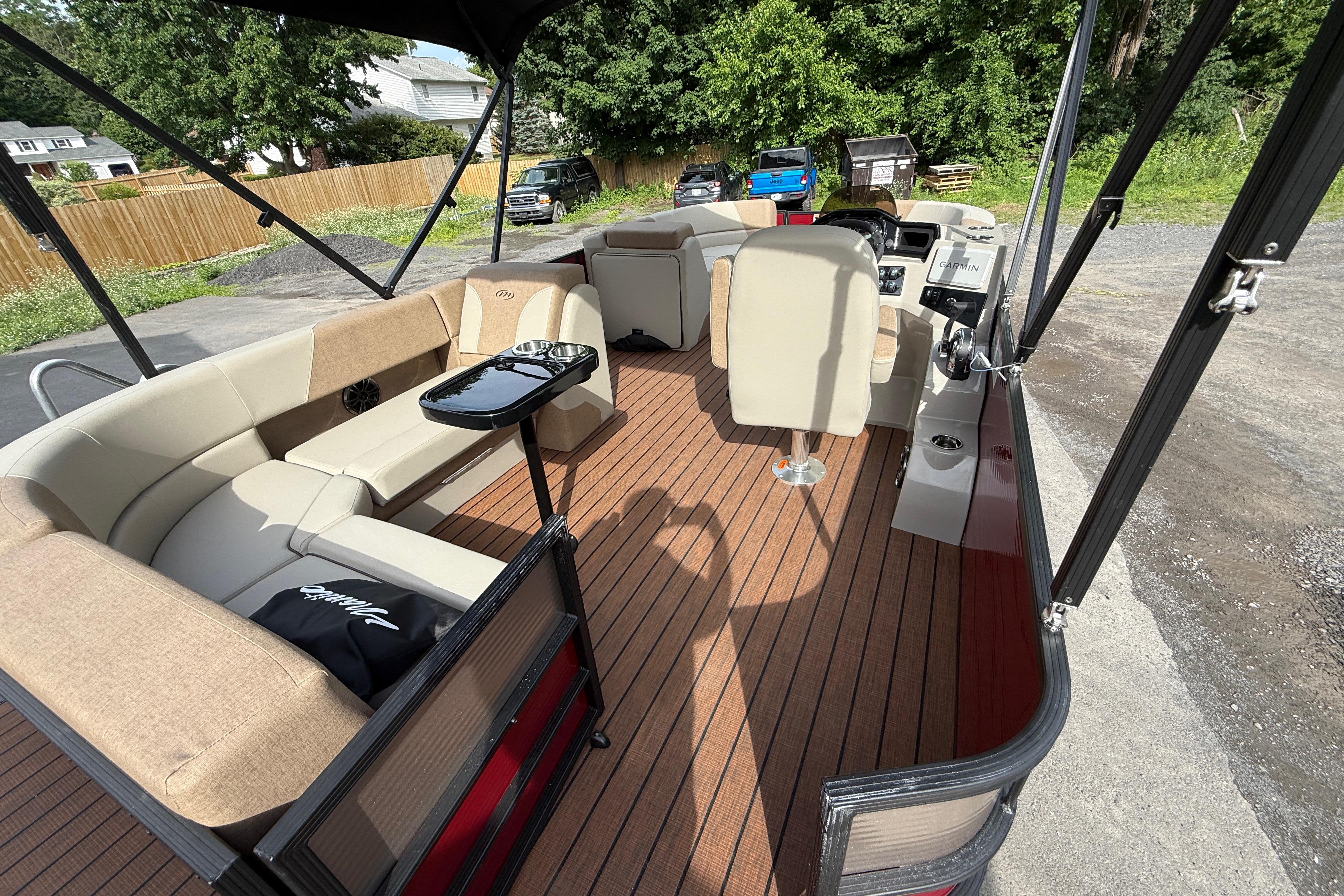 2027 Manitou 21 Aurora LE pontoon boat interior with seating and helm.