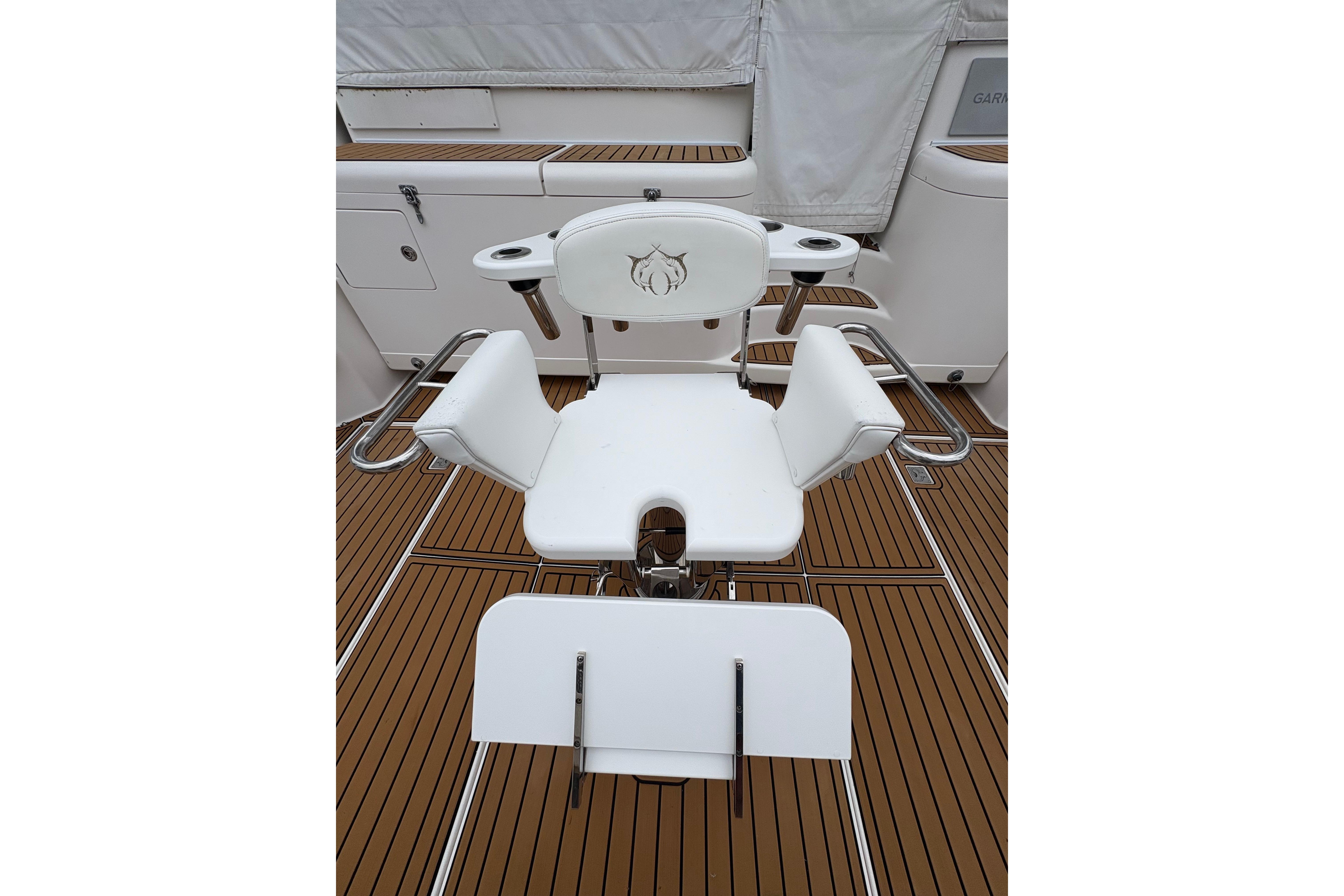 White fishing chair on 2004 Cabo 40 Hardtop Express boat deck.
