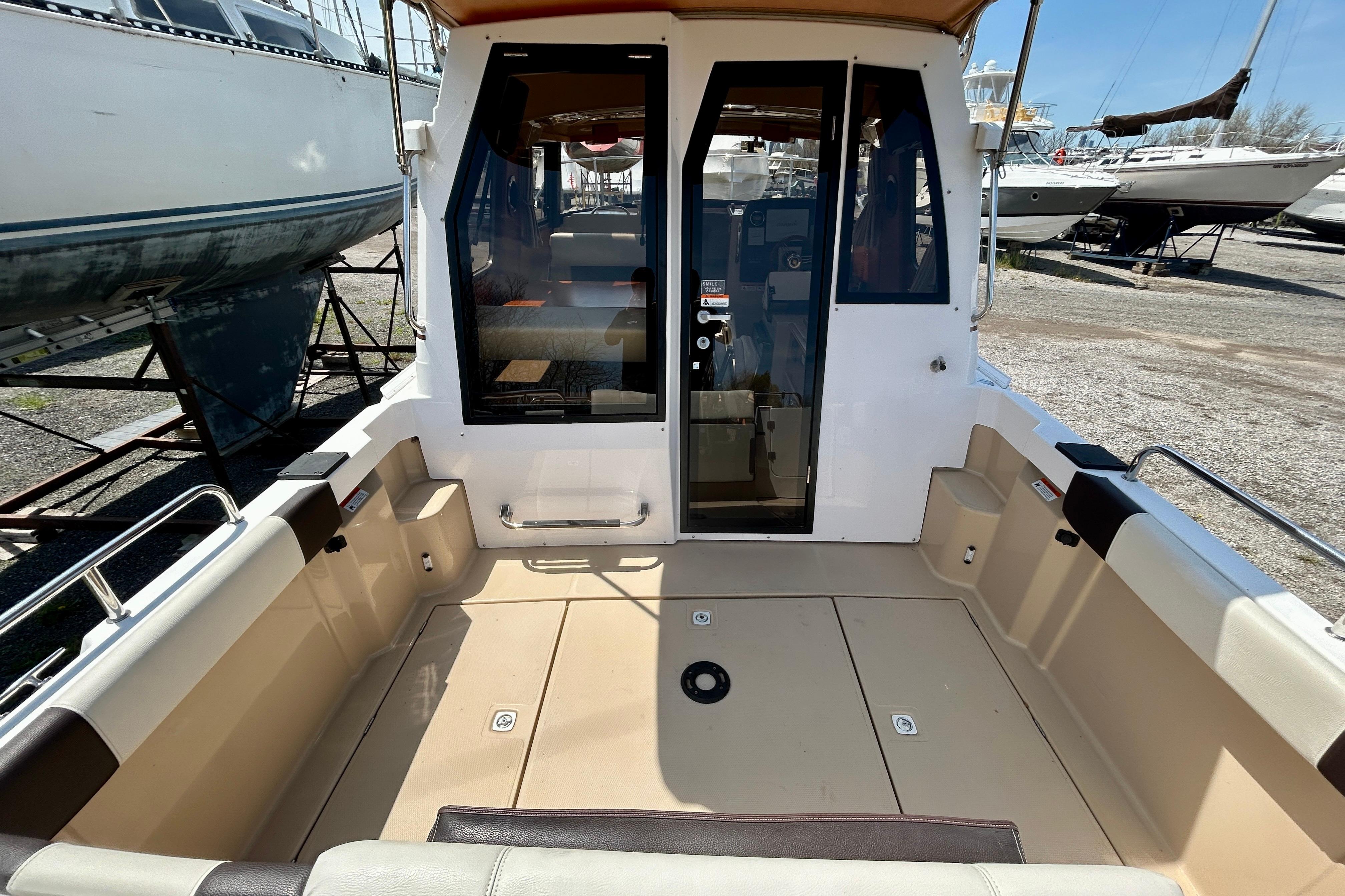 2018 Ranger Tugs R-23 boat cockpit with seating, docked outdoors.