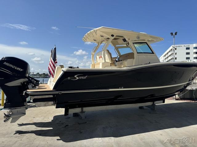 2022 Scout 330 LXF boat with Mercury engine, docked at marina.