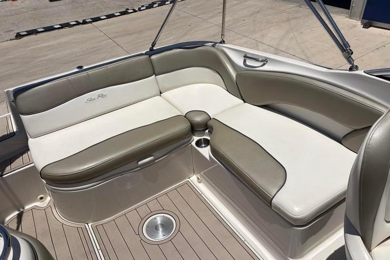 2007 Sea Ray 240 Sundeck interior with beige and white seating, showcasing luxury design.
