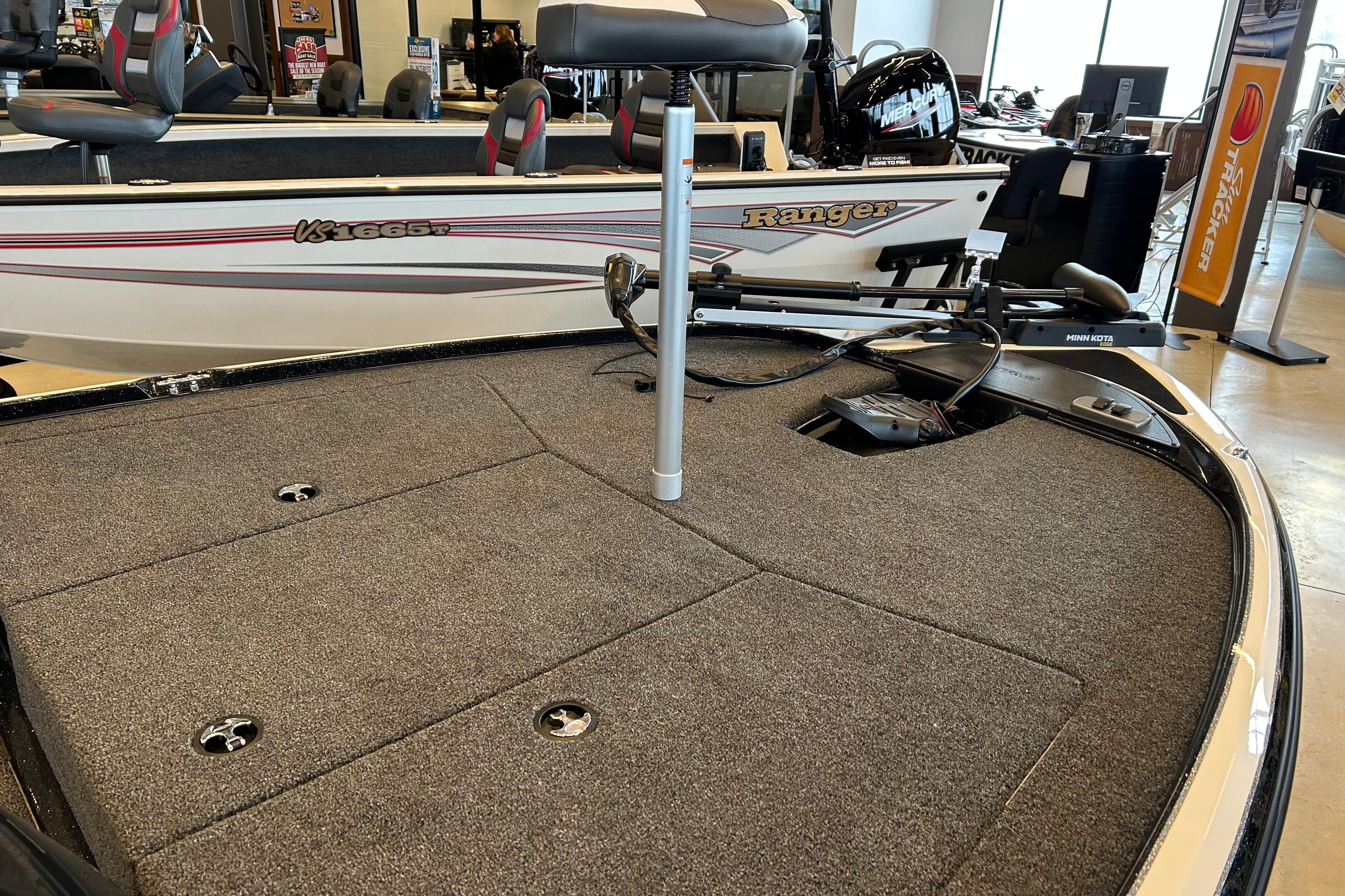 2026 Nitro Z17 boat interior with carpeted deck and fishing equipment.