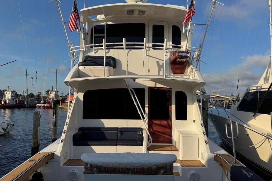 2002 Viking 61 Enclosed Bridge yacht docked at marina, rear view.