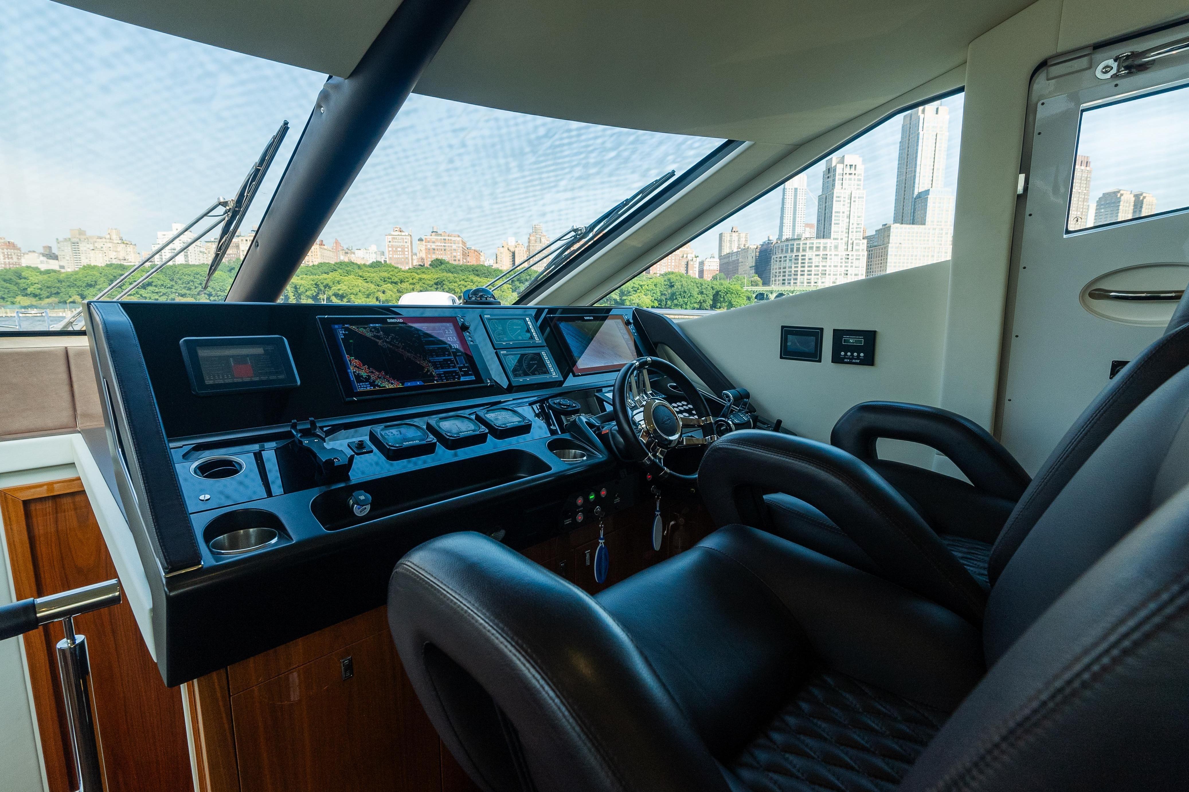 Interior helm of 2016 Sunseeker Manhattan 65 yacht with city skyline view.