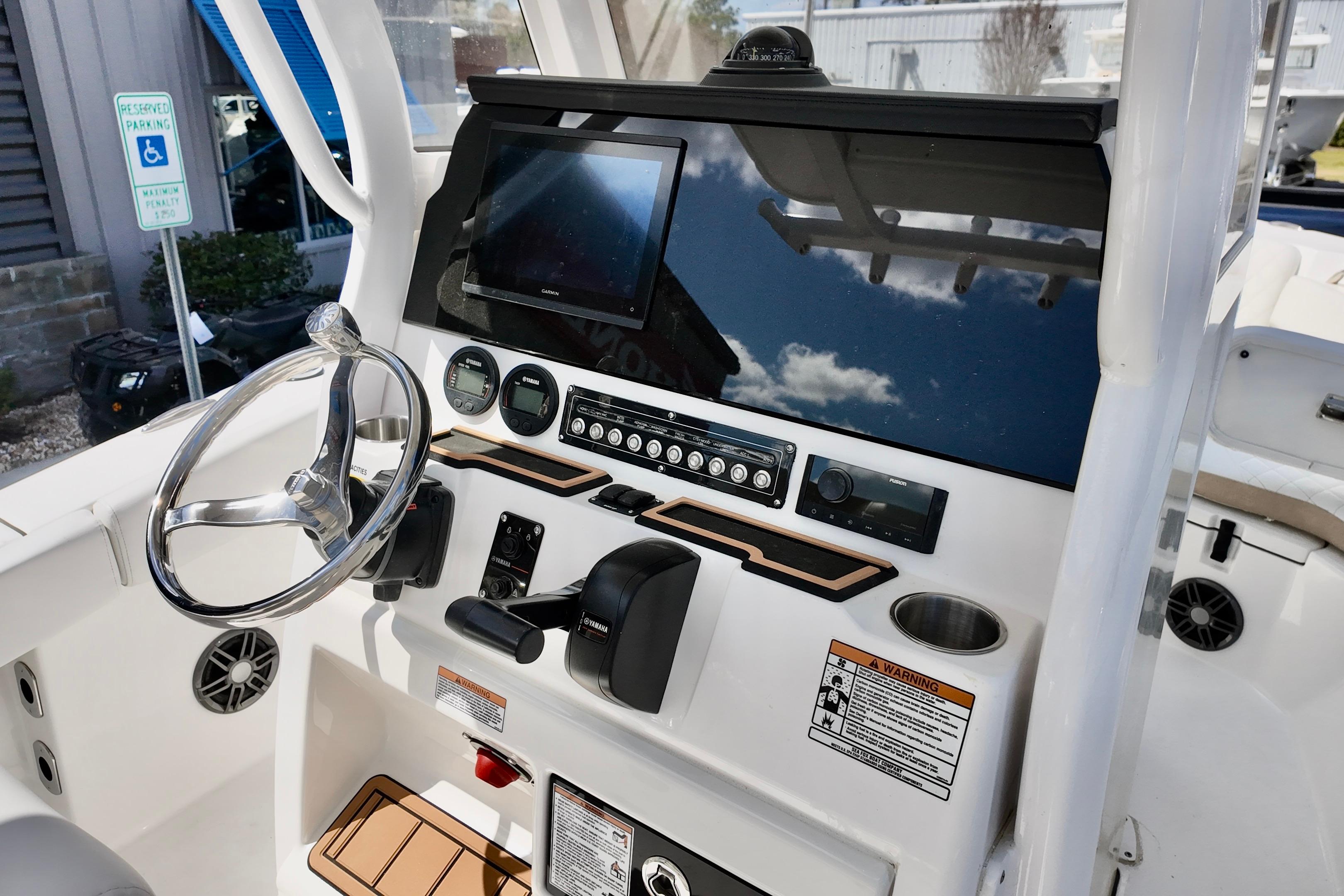 2026 Sea Fox 228 Commander boat dashboard with steering wheel and navigation controls.