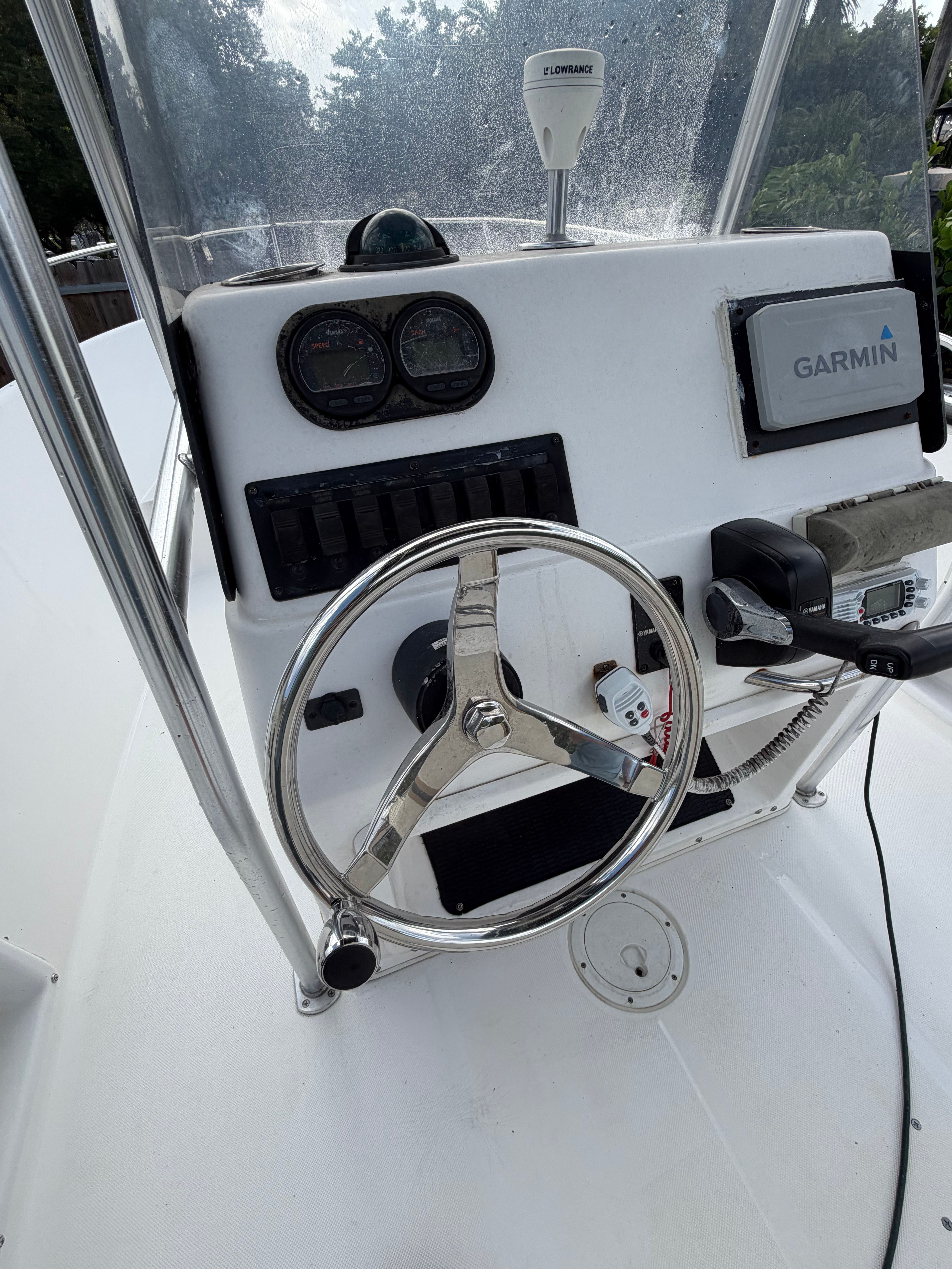 The image shows the helm of a 2001 Century 2100 Center Console boat with a Garmin device.